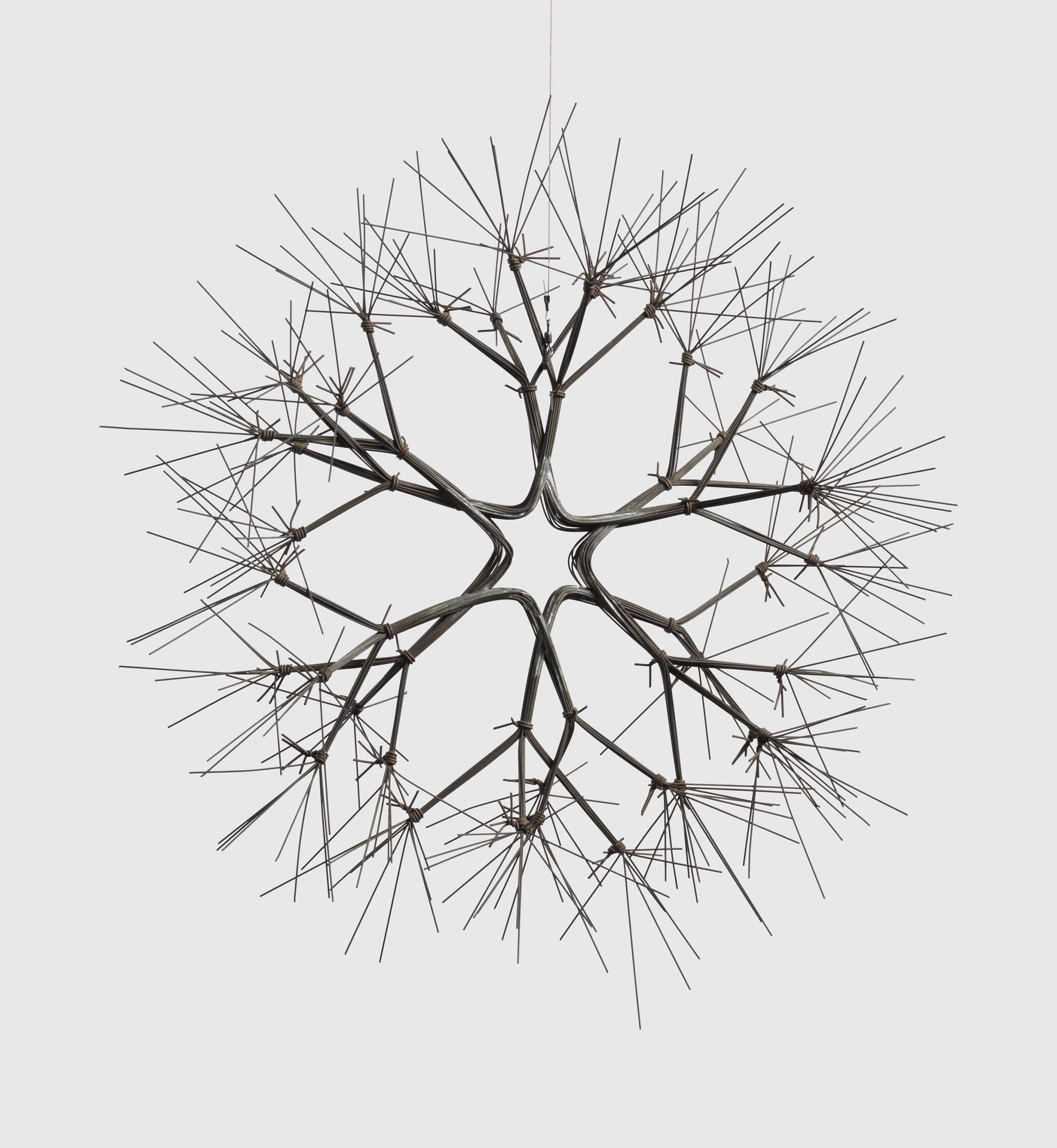 A hanging brass wire sculpture by Ruth Asawa, called Untitled (S.263, Hanging or Wall-Mounted Tied-Wire, Double-Sided, Open-Center, Six-Branched Form Based on Nature), circa 1965.
