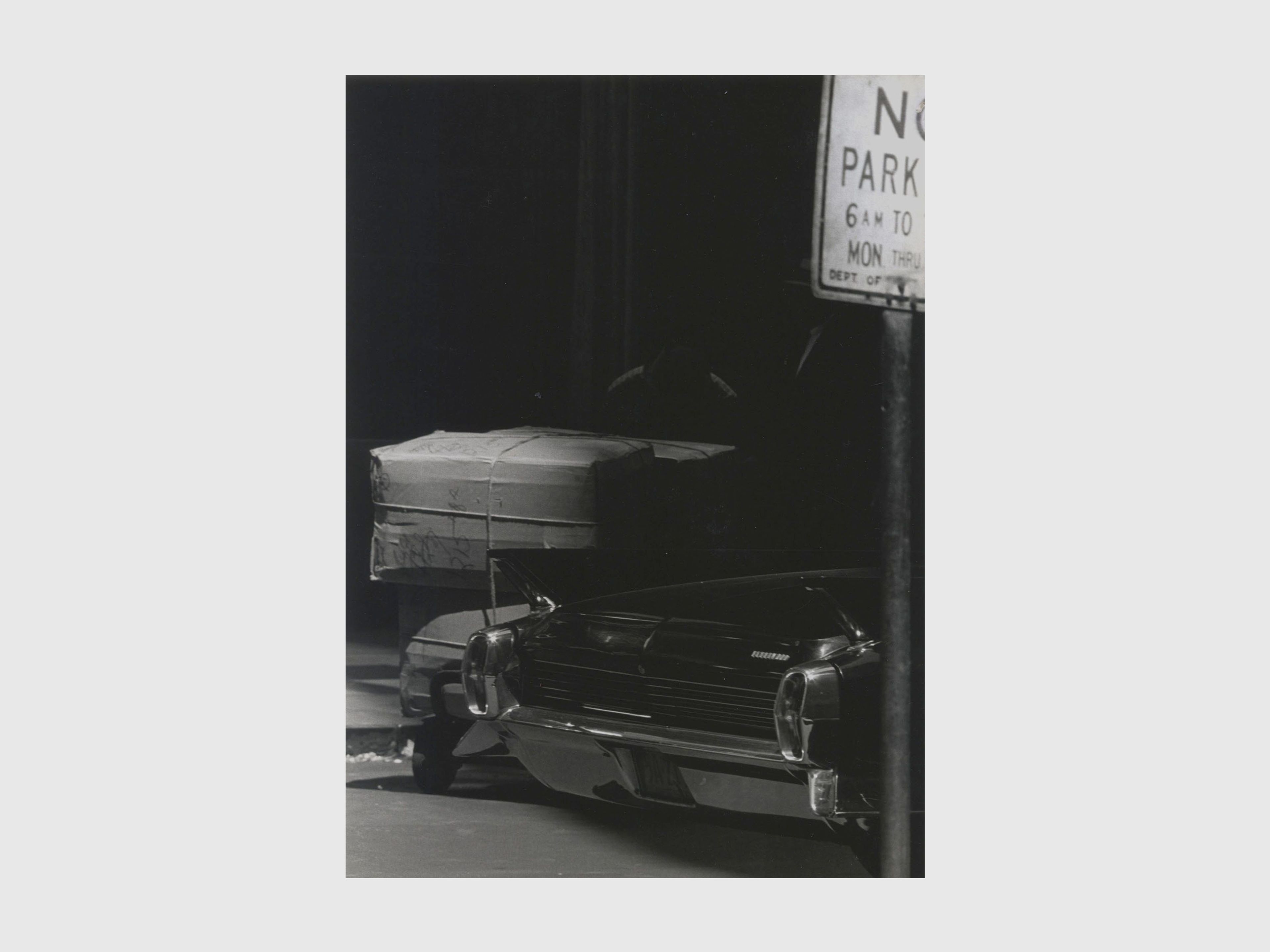 A photograph by Roy de Carava titled Two men boxes and car, dated 1966.