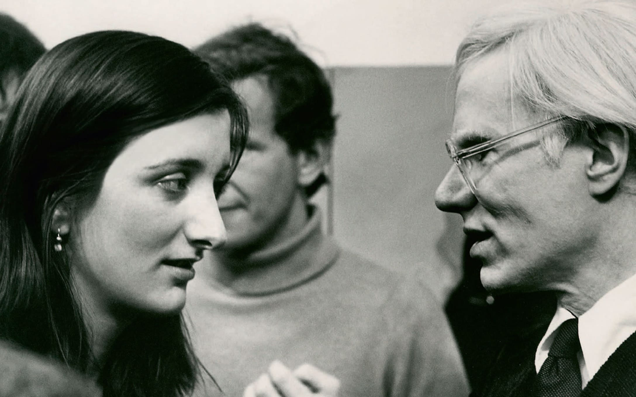 Warhol with Parkett editor-in-chief Bice Curiger on the occasion of his exhibition opening at the Kunsthaus Zurich in 1976.