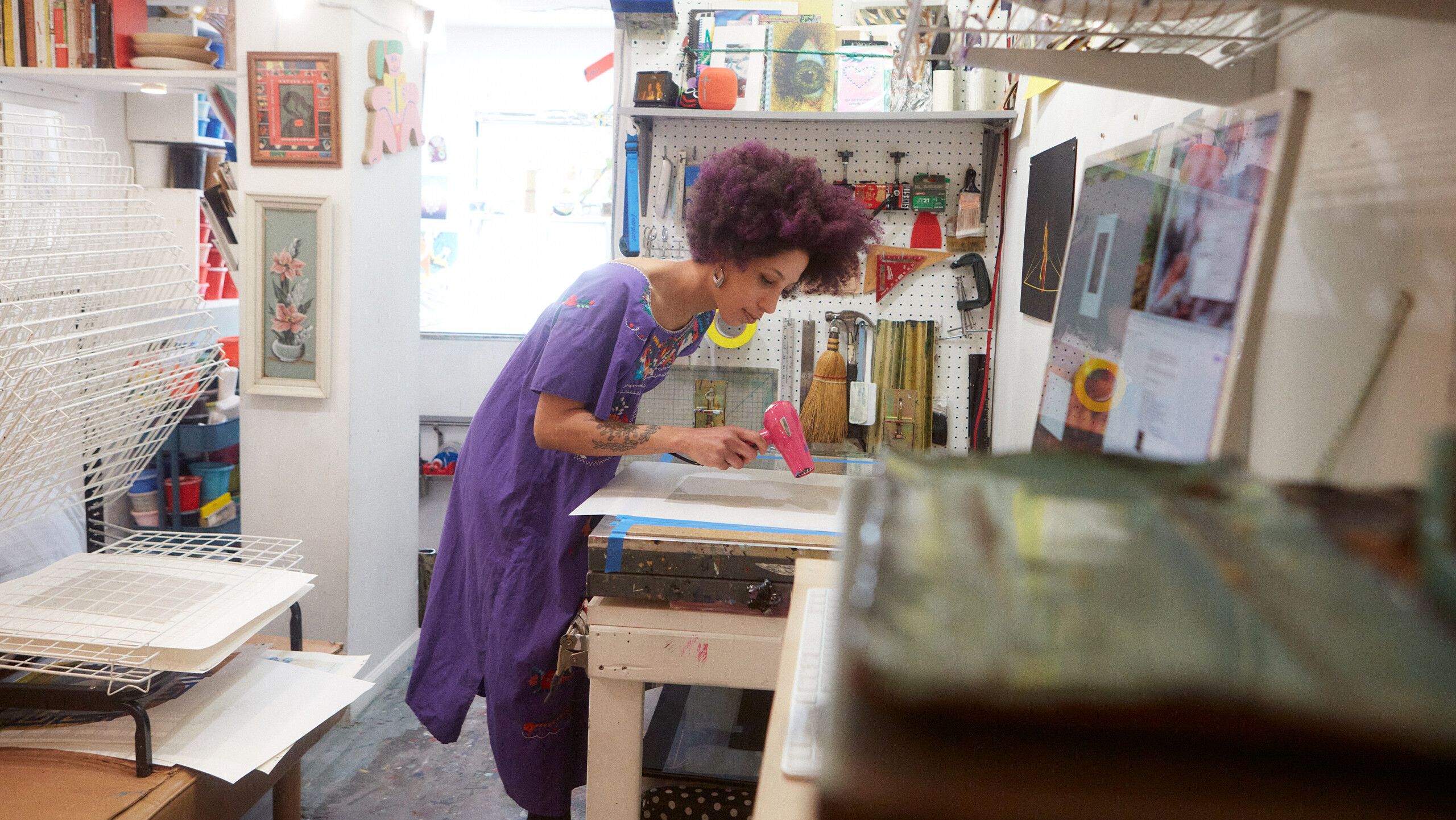 A photograph of Diuguid drying a fresh print by Rafael Rios, dated 2022.