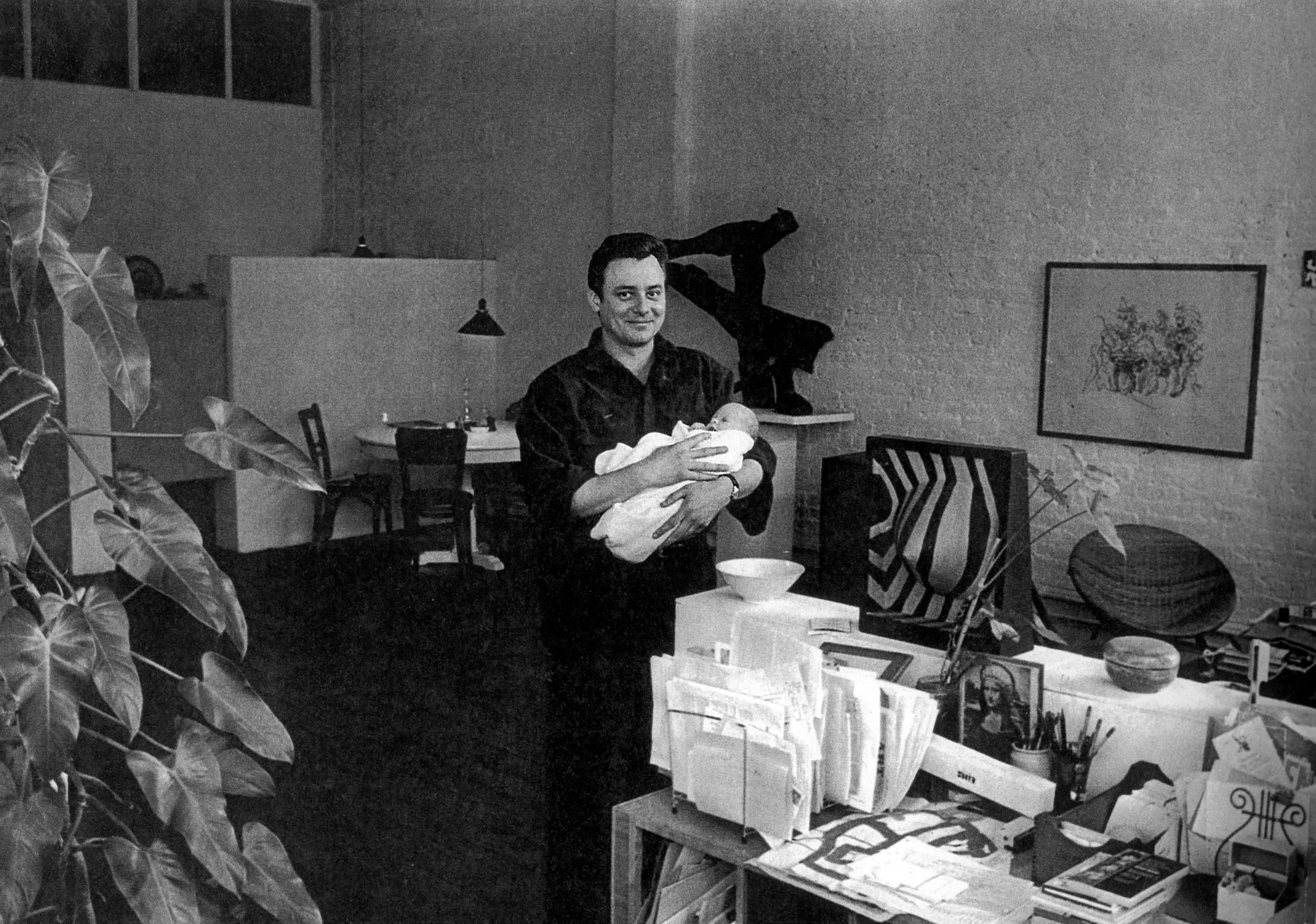 A photo of Robert Ryman with his son, Ethan, in his studio, 163 Bowery, New York, dated 1964