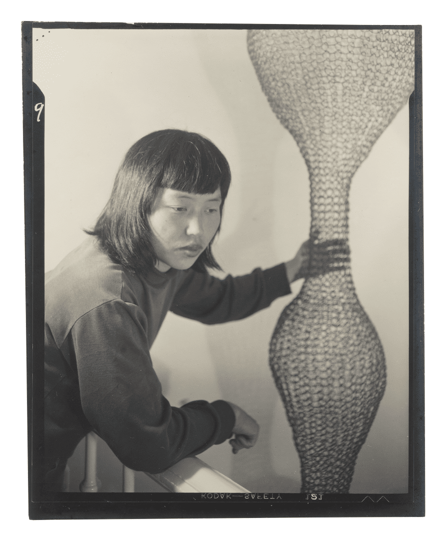 A gelatin silver print by Imogen Cunningham, titled, Ruth Asawa and Her Wire Sculpture 2, dated 1951.