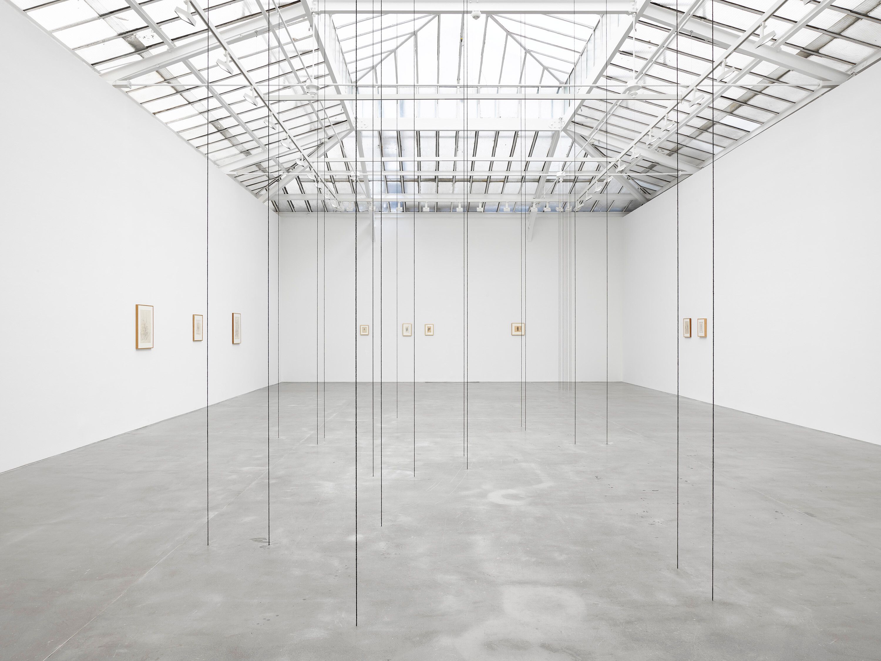 A black acrylic yarn sculpture by Fred Sandback, titled Untitled (Sculptural Study, Nineteen-part Vertical Construction), dated circa 1996 and 2020.