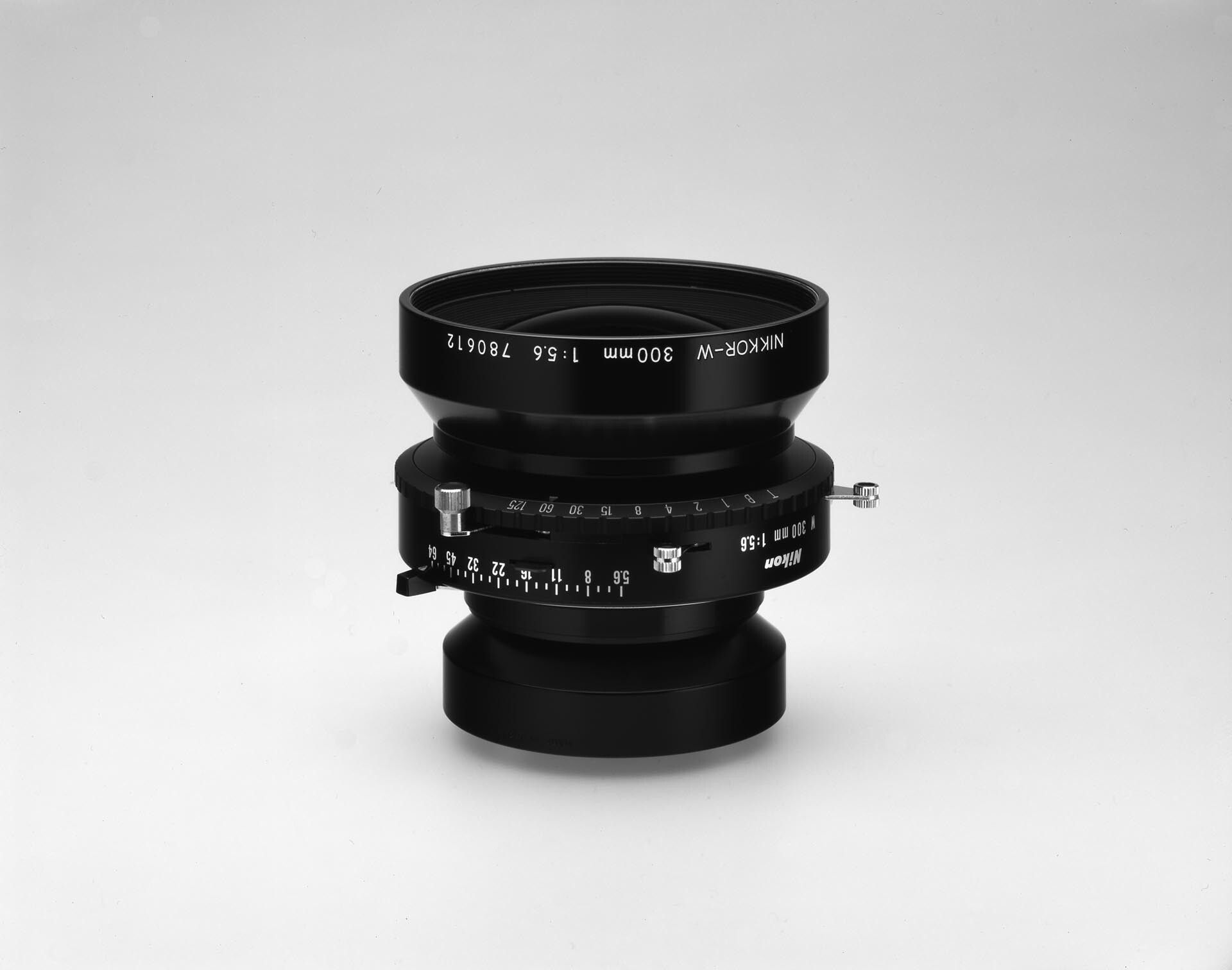 A photograph by Christopher Williams, titled Nikkor W 300 mm f/5.6 with No. 3 Shutter, 1:5.6, Product Aperture f/64, Product Number 1320 NAS, Serial Number 780612, Large Format Camera Lens., dated 2005.