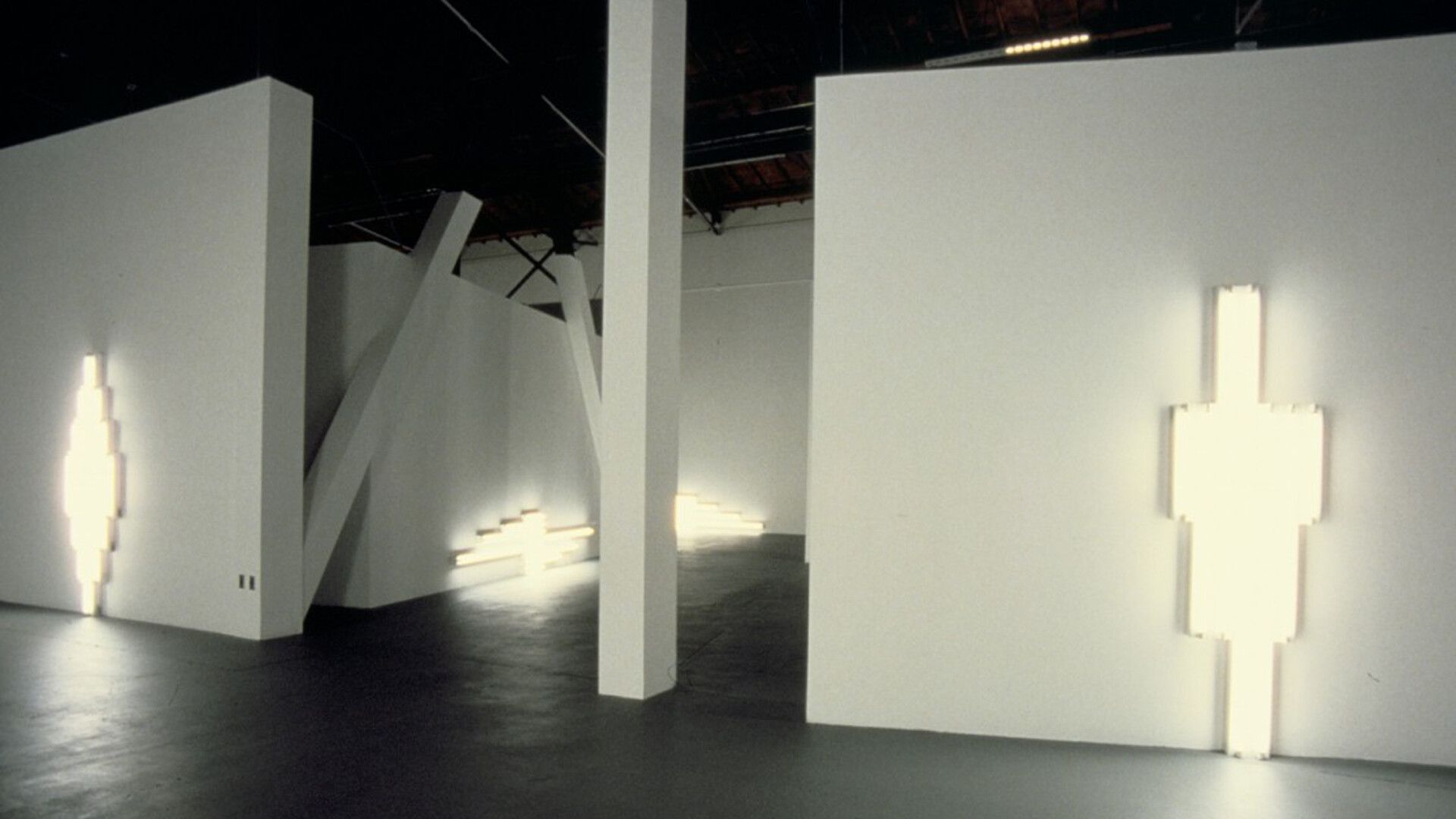 An installation view of "monuments" for V. Tatlin by Dan Flavin in the exhibition Dan Flavin, 1964-1983, at MoCA Temporary Contemporary in Los Angeles, dated 1984.