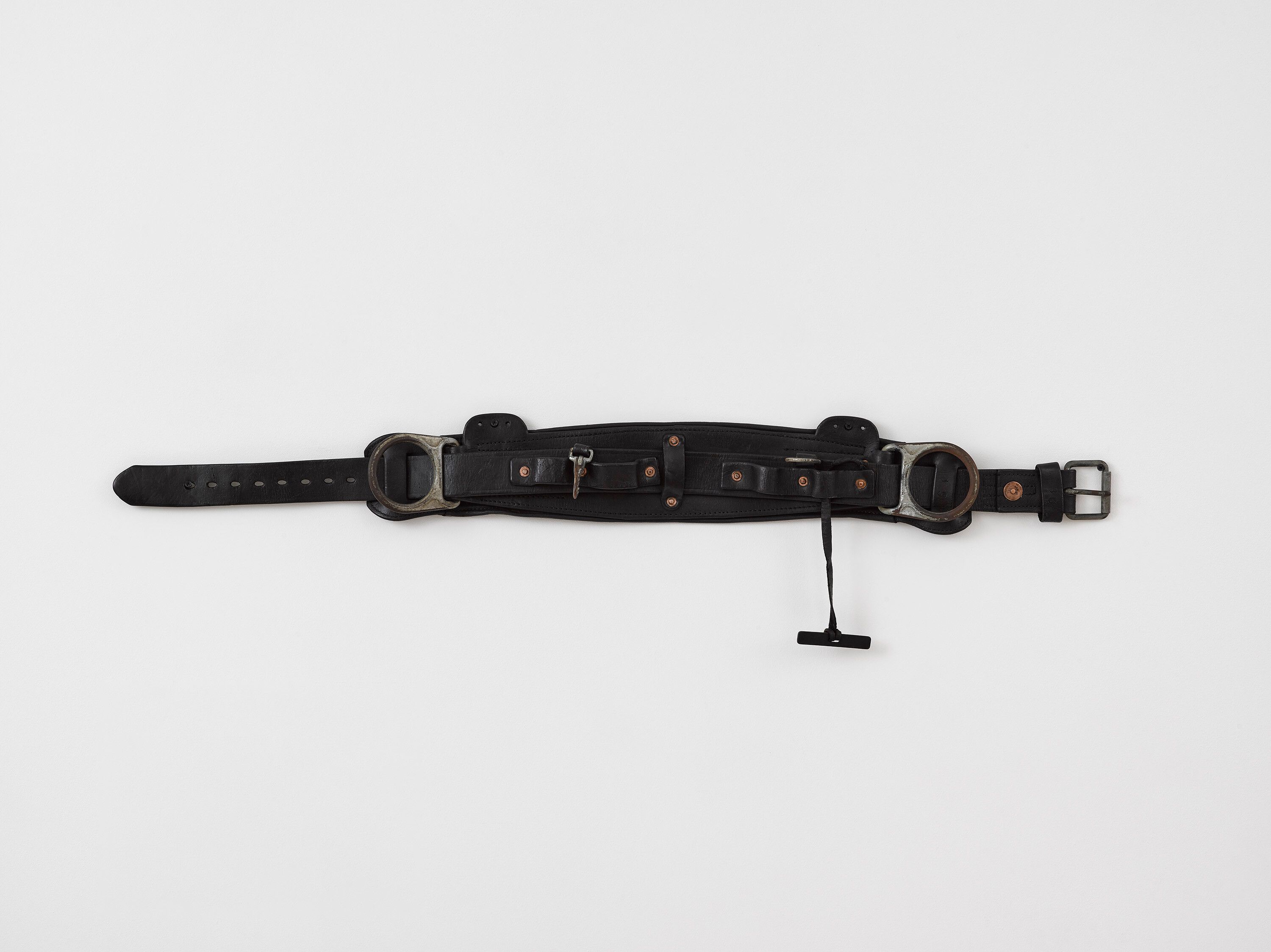A leather lineman harness, steel, leather dye, Saphir shoe polish, and spit artwork by Tiona Nekkia McClodden, titled A.B. 5_Dull 1299, dated 2021. 