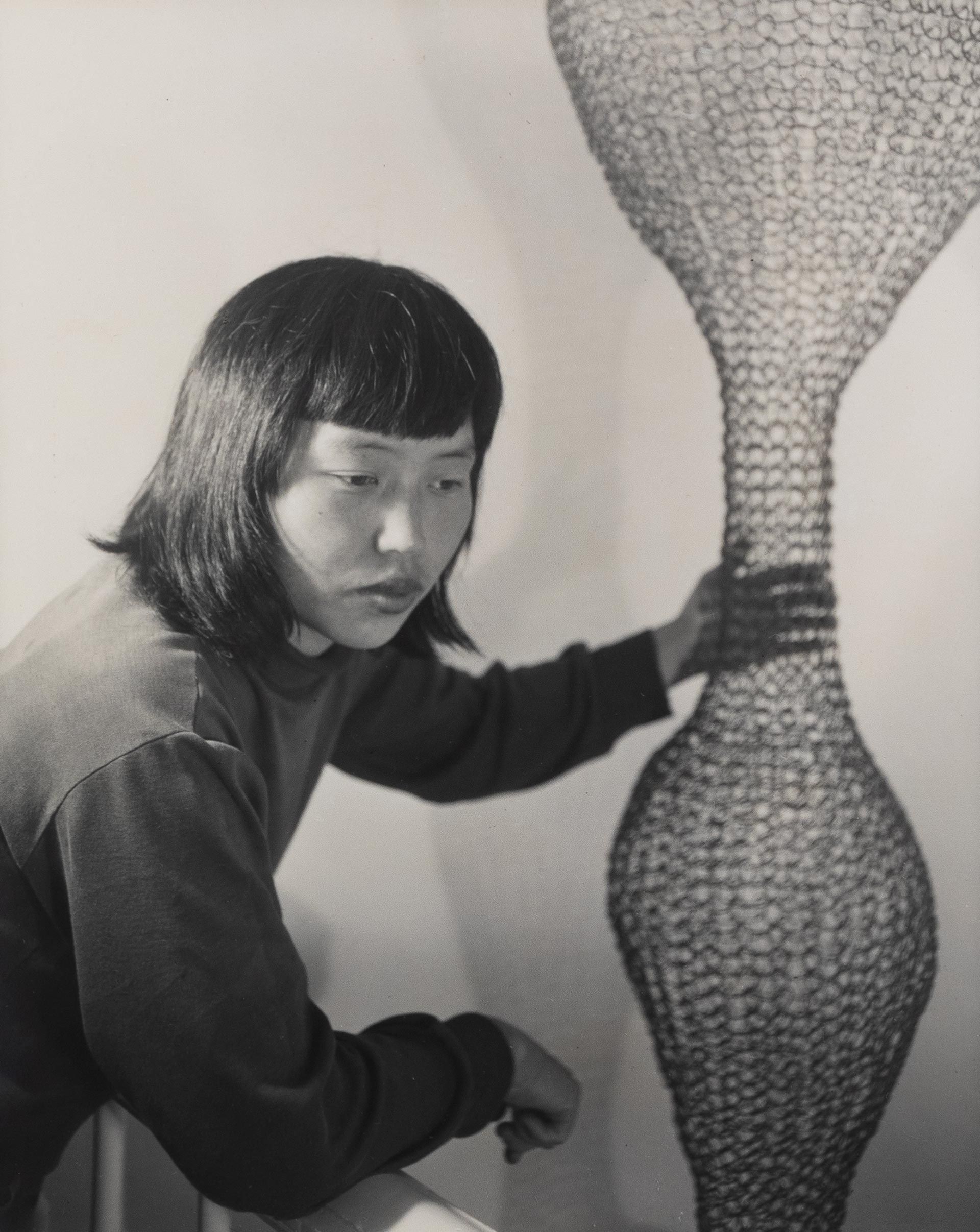 A photo titled Ruth Asawa and Her Wire Sculpture 2, dated 1951. Photo by Imogen Cunningham.