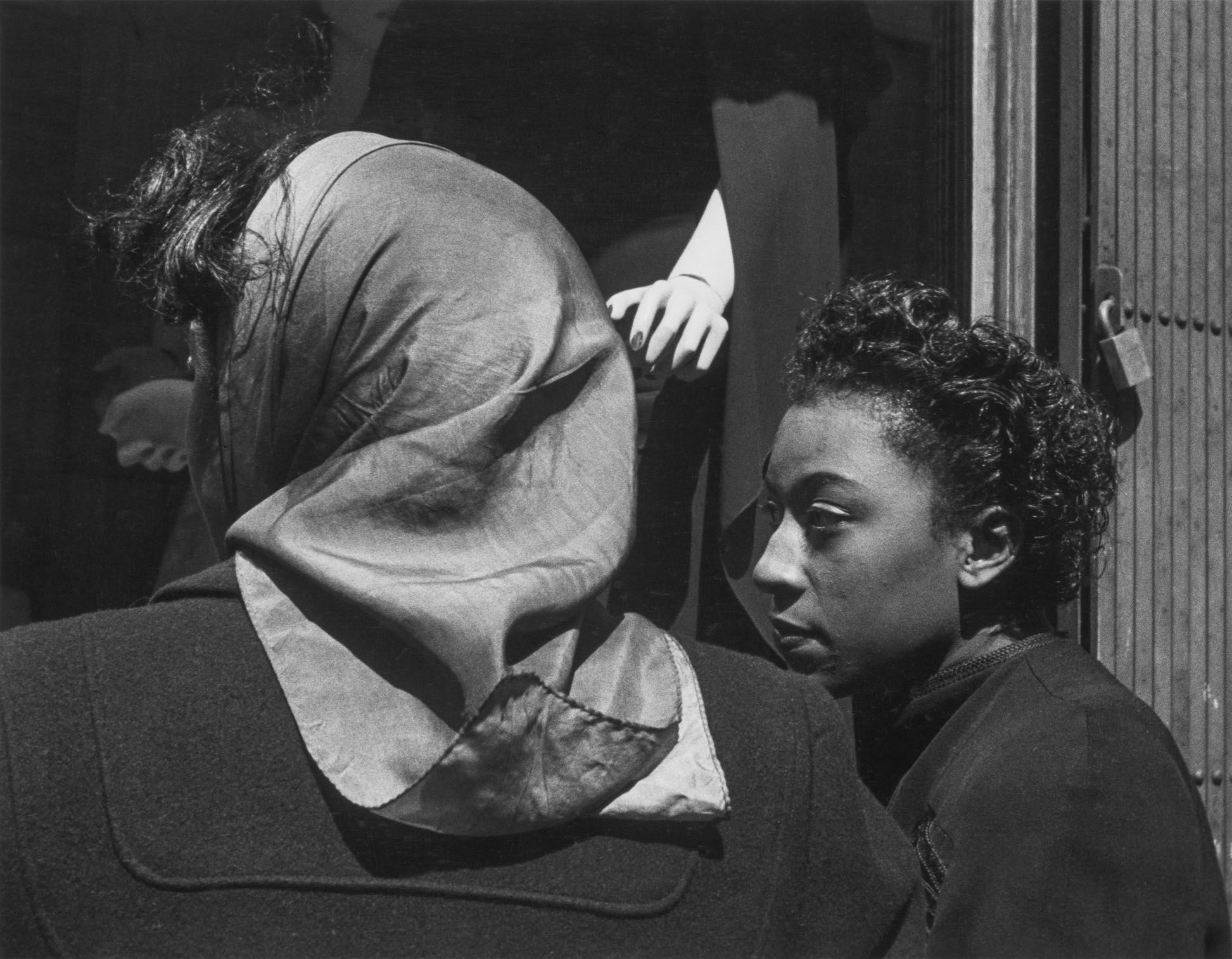 A photograph by Roy DeCarava titled Two women, mannequin’s hand, dated 1952