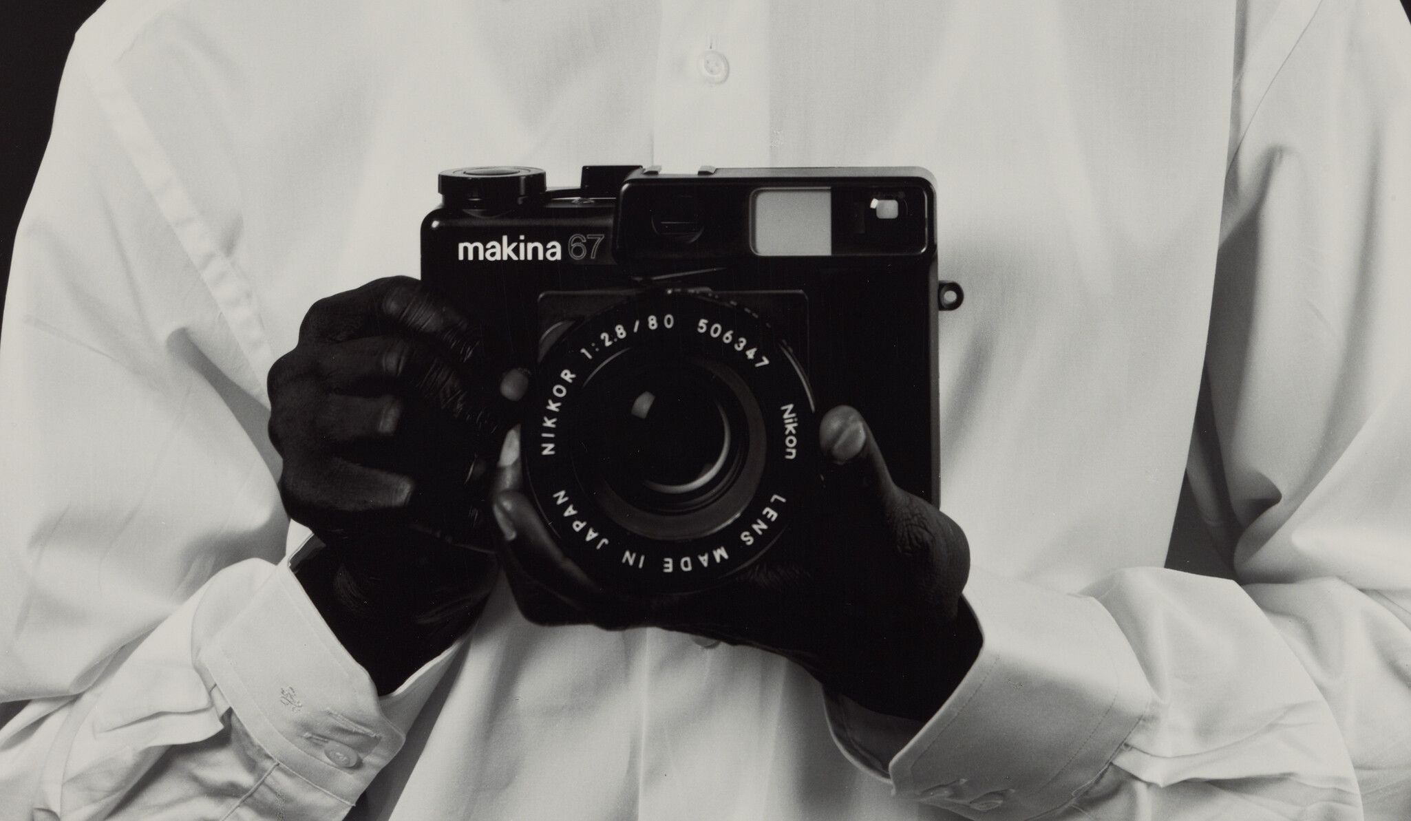 A detail from a photograph by Christopher Williams titled Mustafa Kinte (Gambia) Camera: Makina 67 506347 Plaubel Feinmechanik und Optik GmbH Borsigallee 37 60388 Frankfurt am Main, Germany Shirt: Van Laack Shirt Kent 64 41061 Mönchengladbach, Germany Dirk Schaper Studio, Berlin July 20, 2007, dated 2008