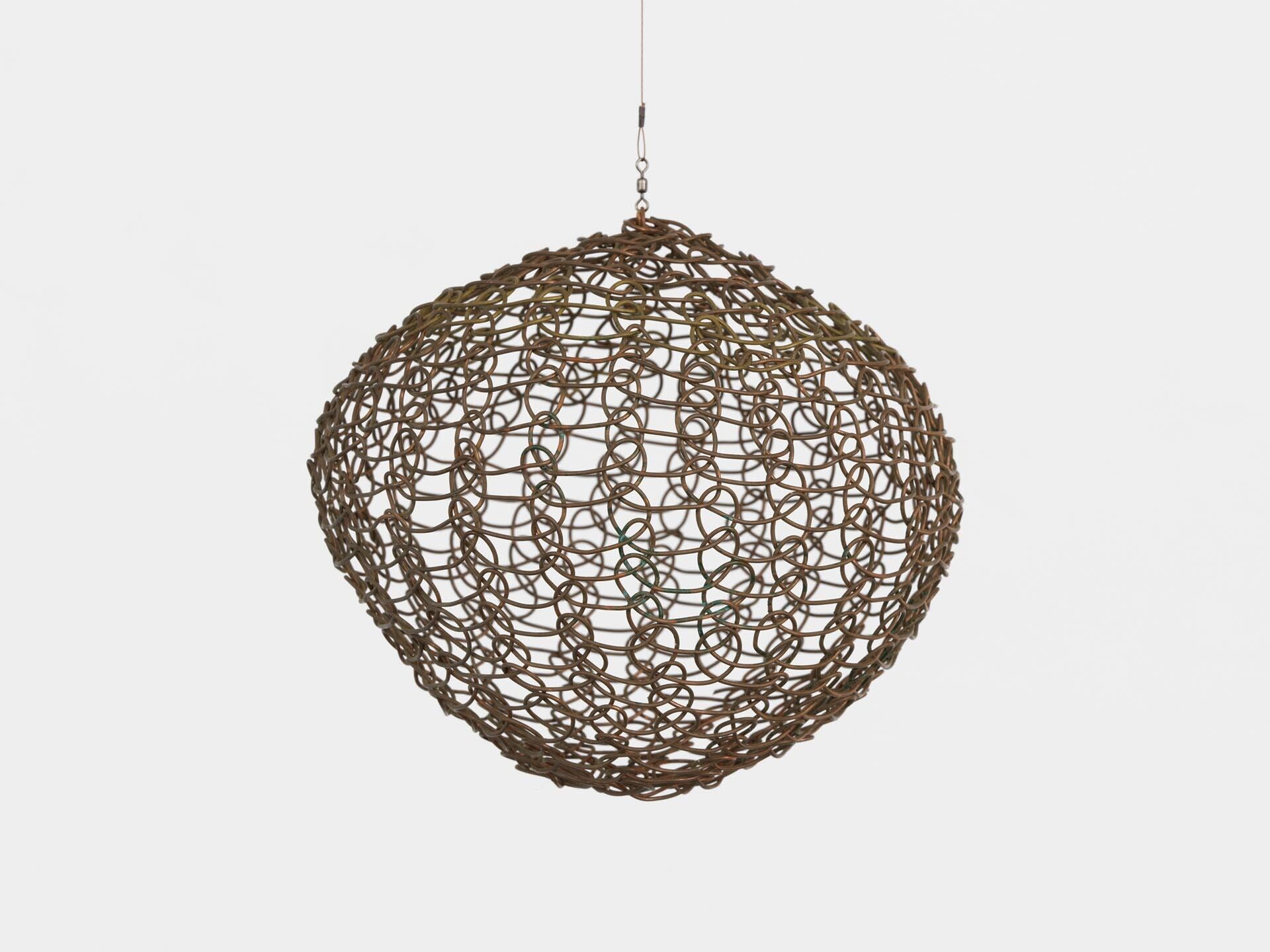 A sculpture by Ruth Asawa, titled Untitled (S.582, Hanging Sphere), dated circa 1956.