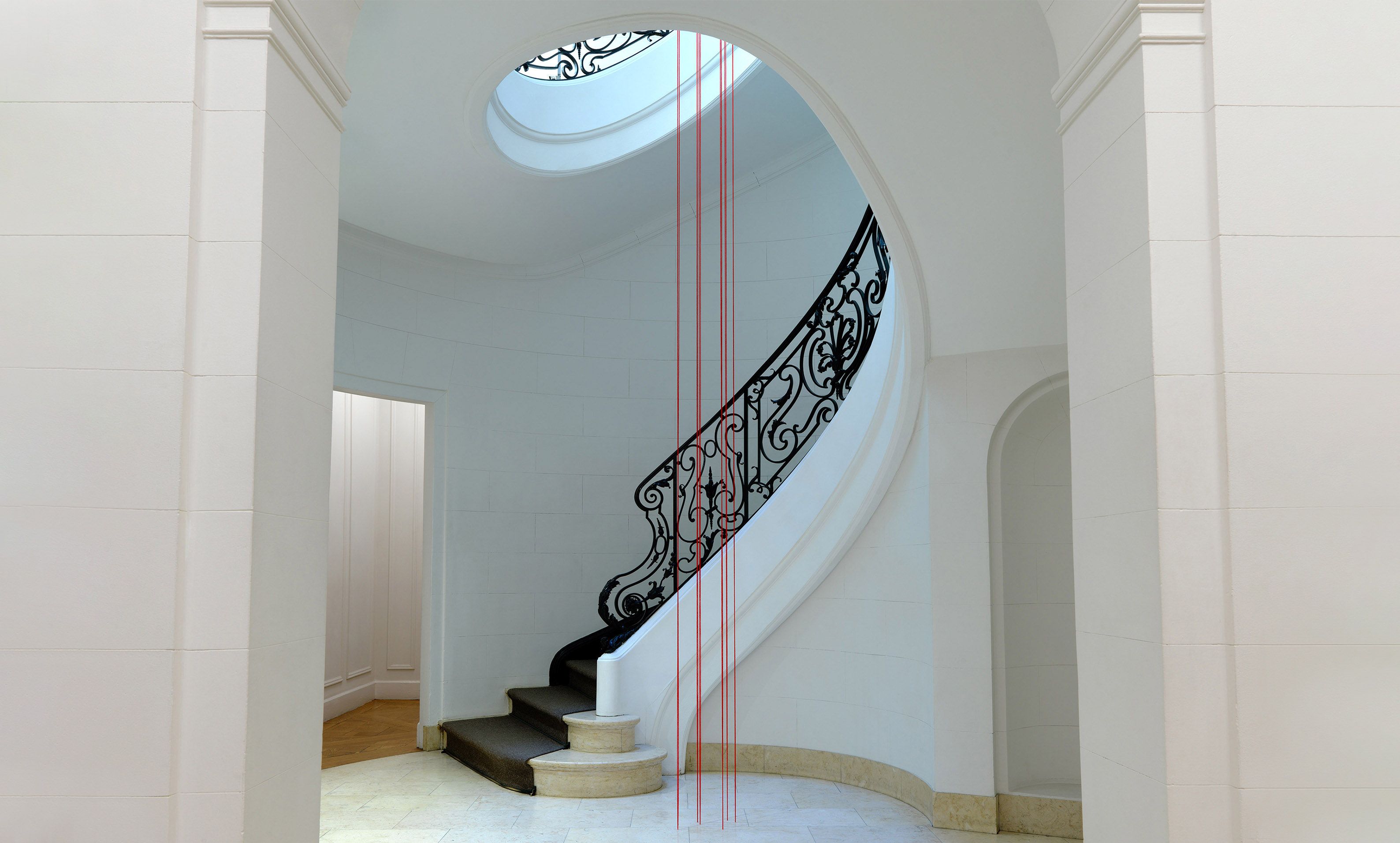 A red acrylic yarn artwork by Fred Sandback, titled Untitled (Sculptural Study, Six-part Vertical Construction), circa 1983 and 2022.