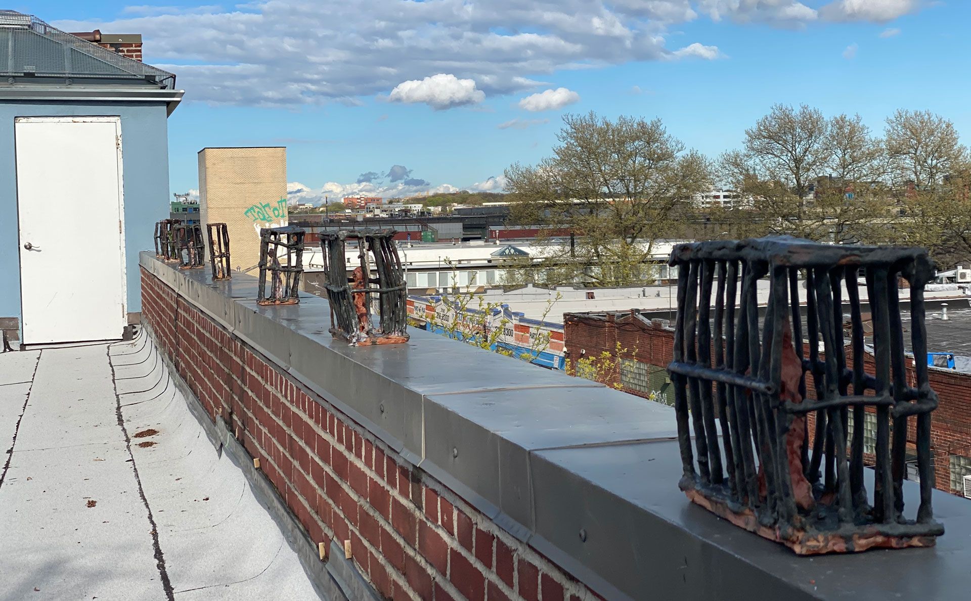 An installation view of the exhibition titled Josh Smith: High As Fuck on the artist's studio roof in Brooklyn, New York, dated 2020.