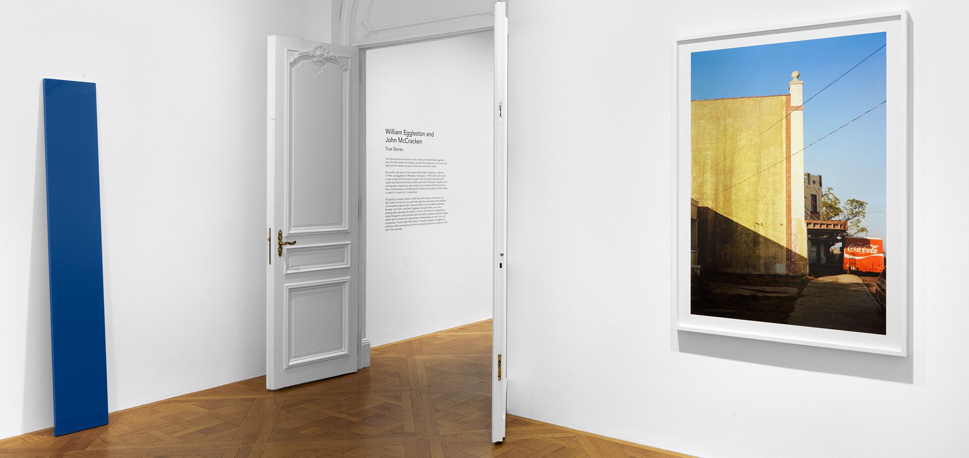 An installation view of an exhibition titled William Eggleston and John McCracken: True Stories, at David Zwirner New York, in 2021.