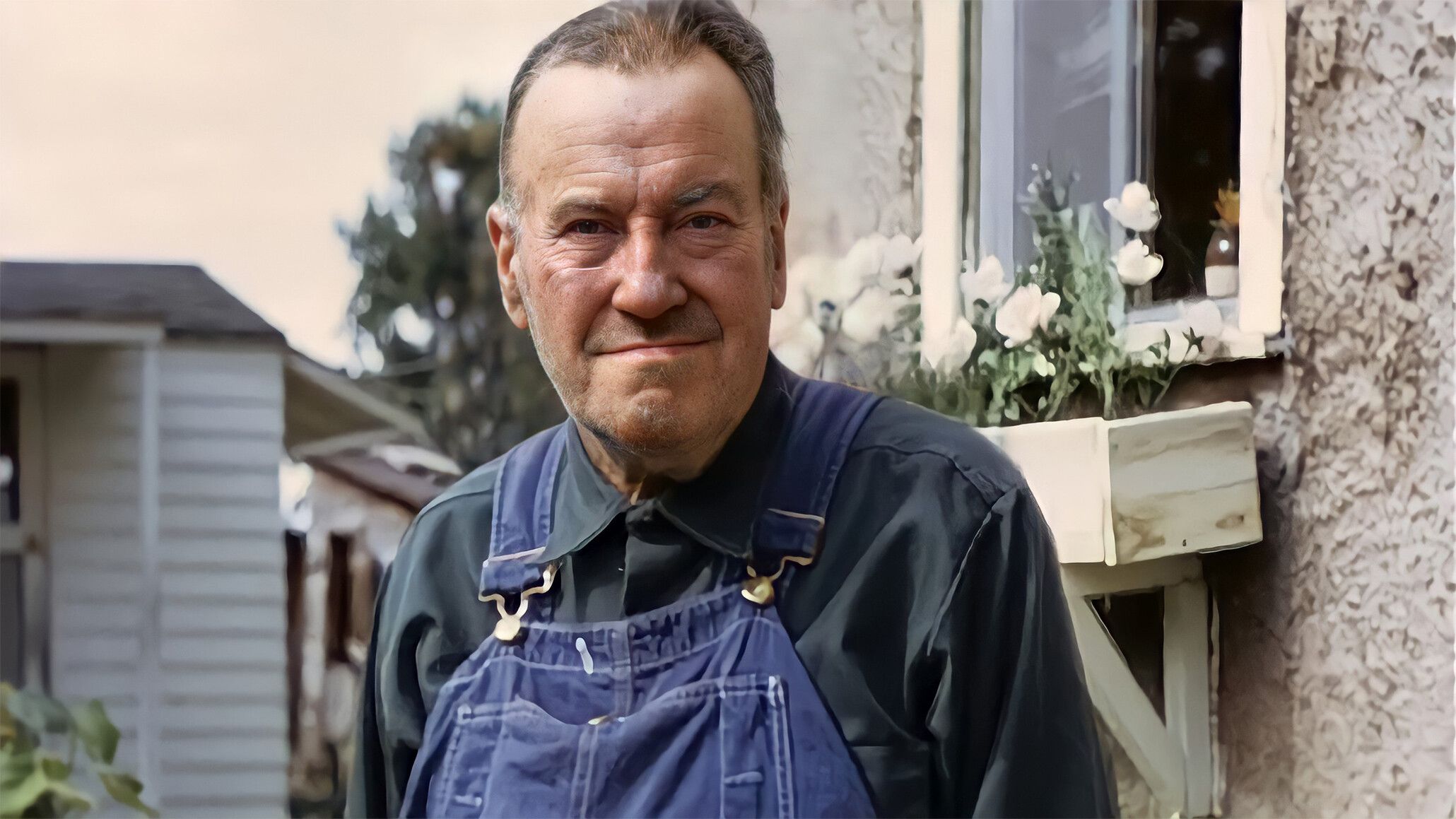A photograph of James Castle outside of his home