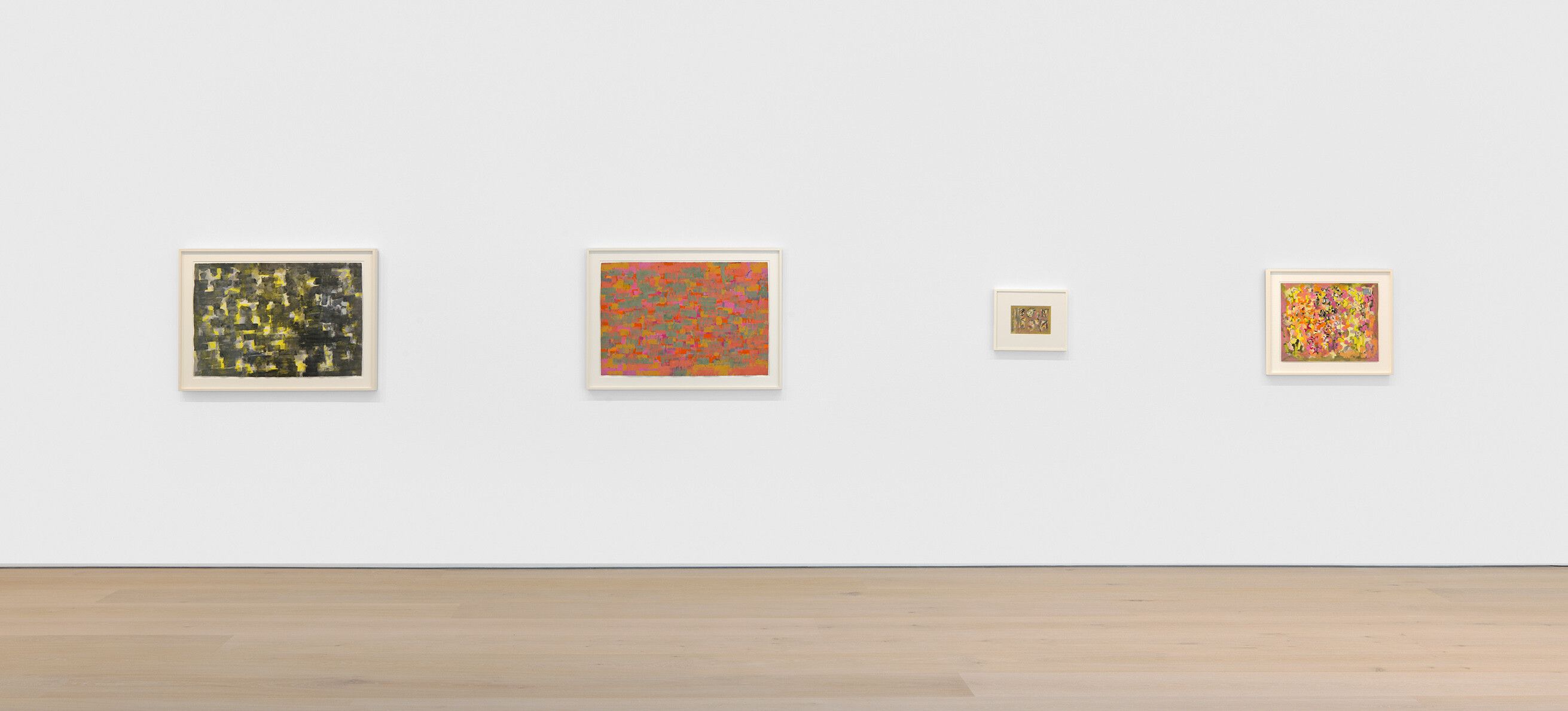 An installation view features paintings by Ad Reinhardt