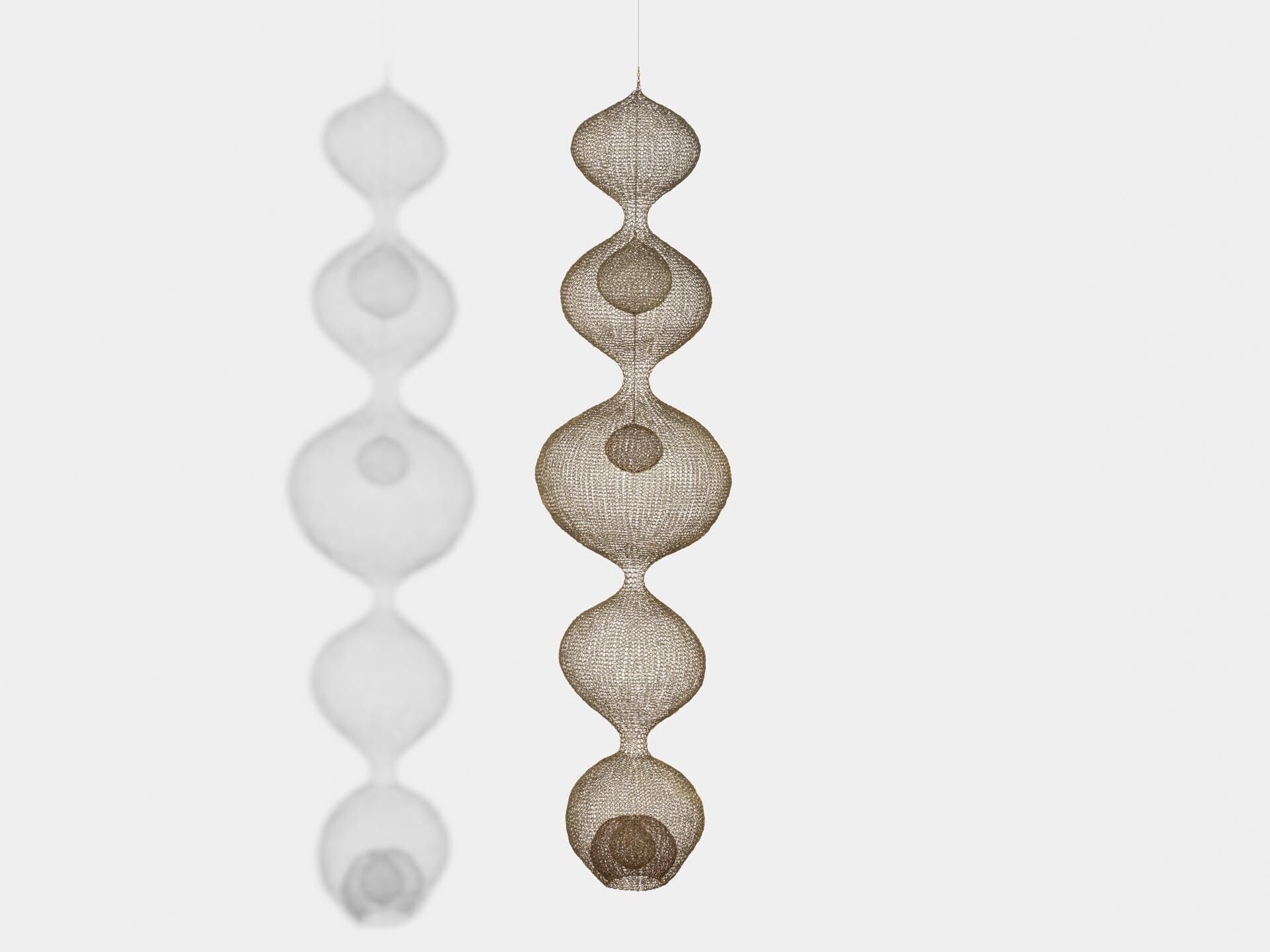 A sculpture by Ruth Asawa, titled Untitled (S.407, Hanging, Five-Lobed, Continuous Form within a Form with Two Spheres), dated circa 1952.