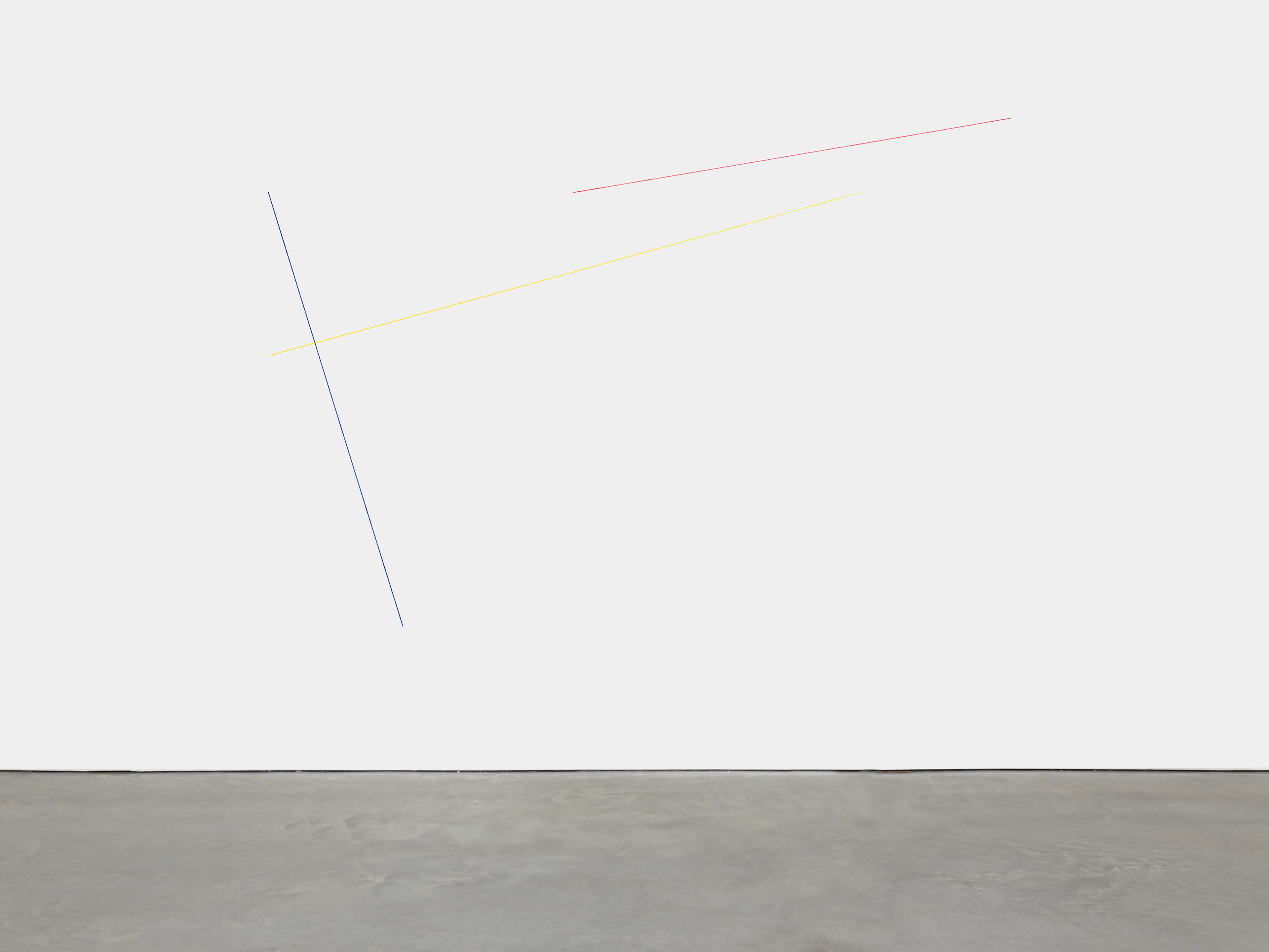 A blue, yellow, and red acrylic yarn artwork by Fred Sandback, titled Untitled (Sculptural Study, Three-part Wall Construction), 1985 and 2018.