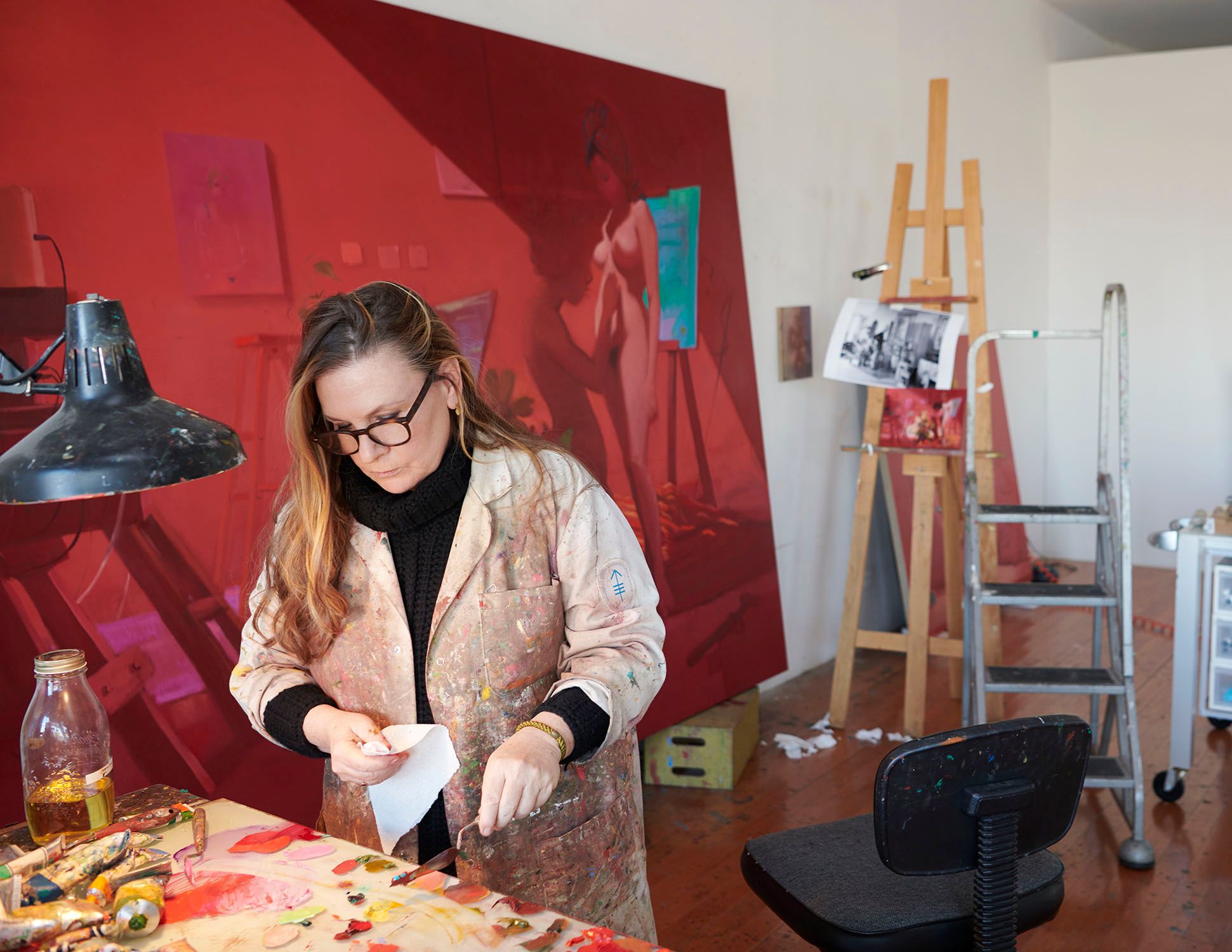 A photograph of Lisa Yuskavage in her studio, dated 2019
