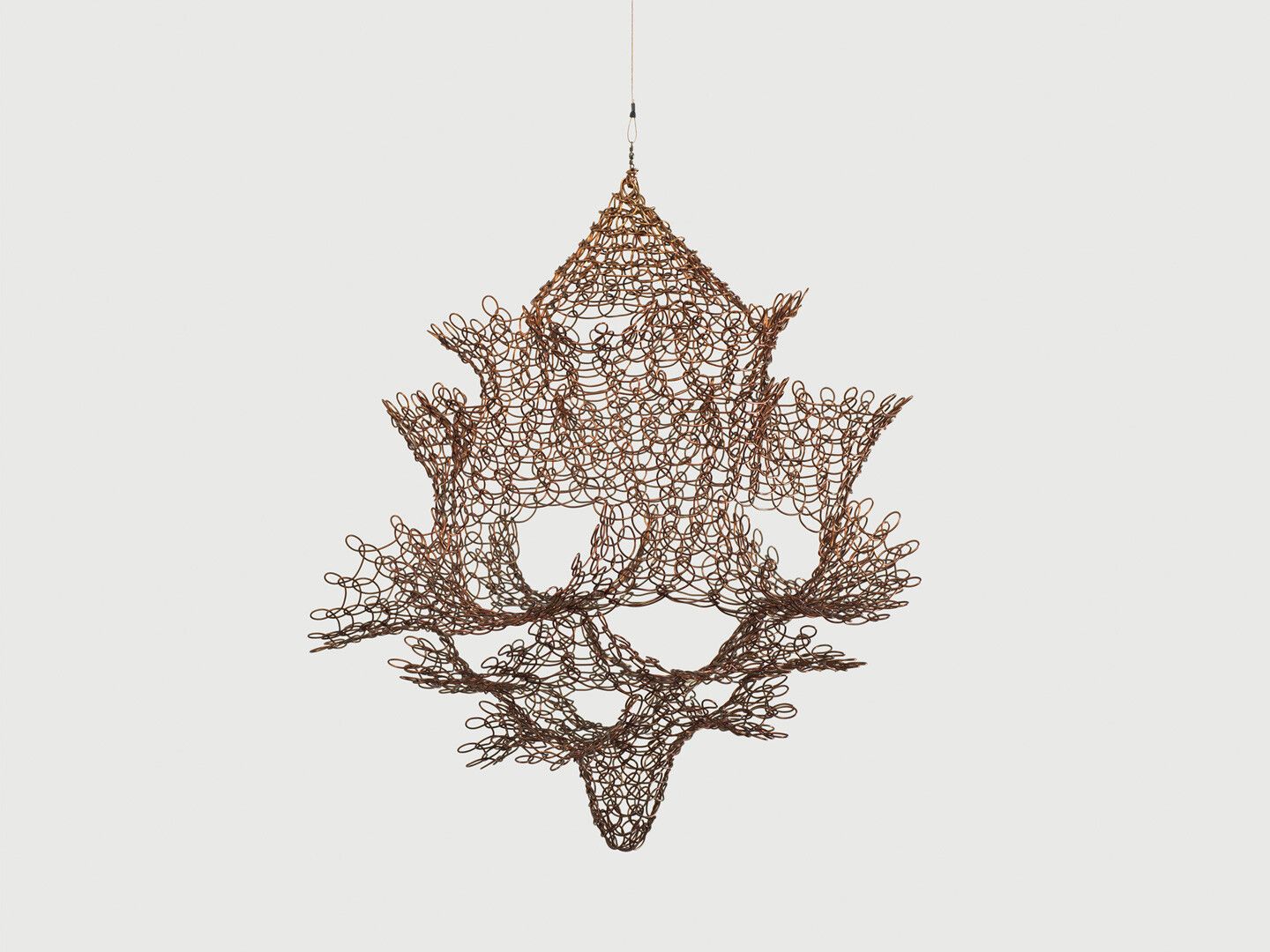A hanging copper wire sculpture by Ruth Asawa, titled Untitled (S.595, Hanging Single Section, Reversible Open Windows Form), circa 1963.