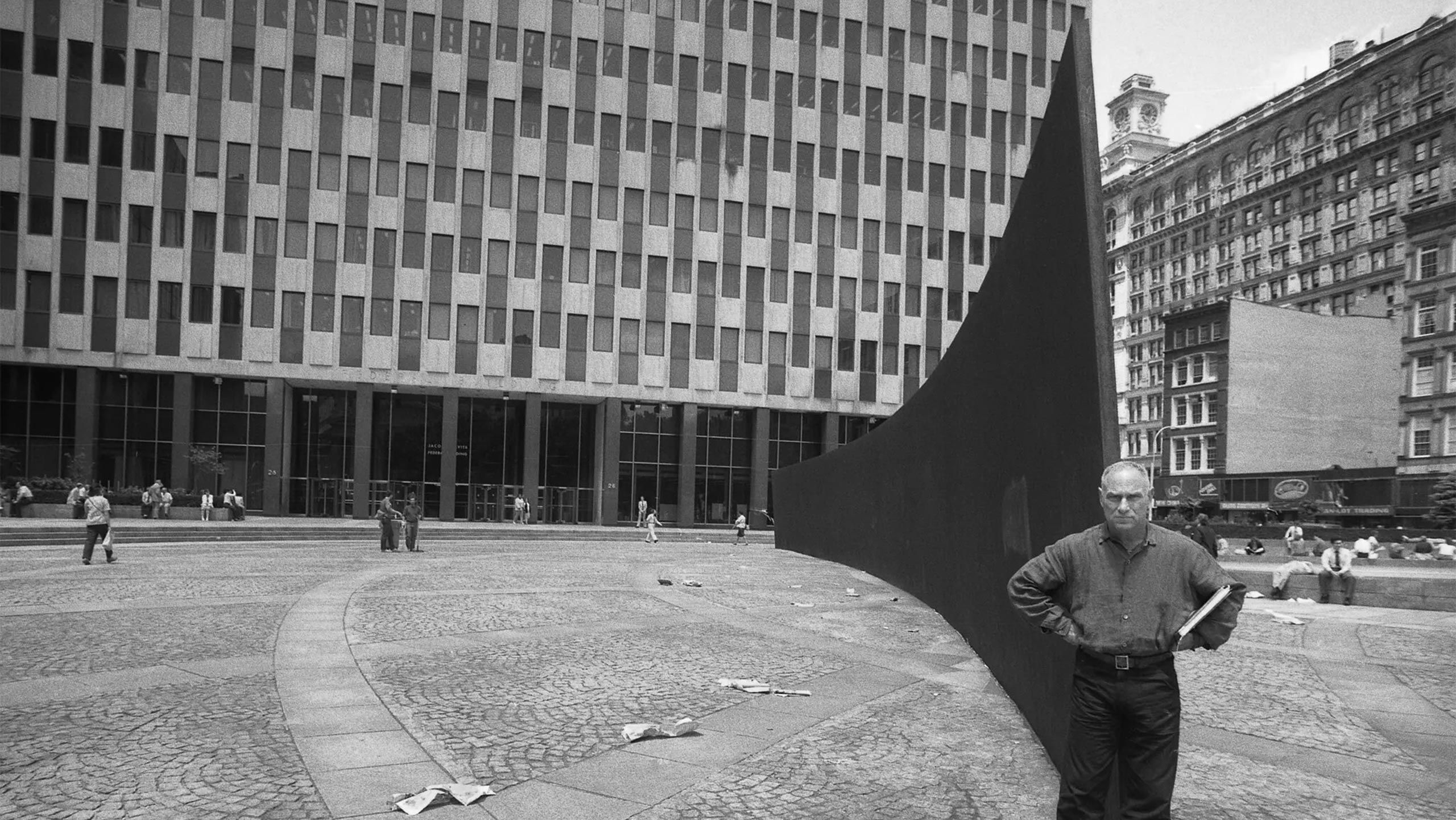 Richard Serra with his massive steel sculpture “Tilted Arc” (1981) in Federal Plaza, in the mid-1980s. The public art was the subject of much debate and controversy, and was eventually dismantled in 1989.Credit...Oliver Morris/Getty Images; 2024 Richard Serra/Artists Rights Society (ARS), New York
