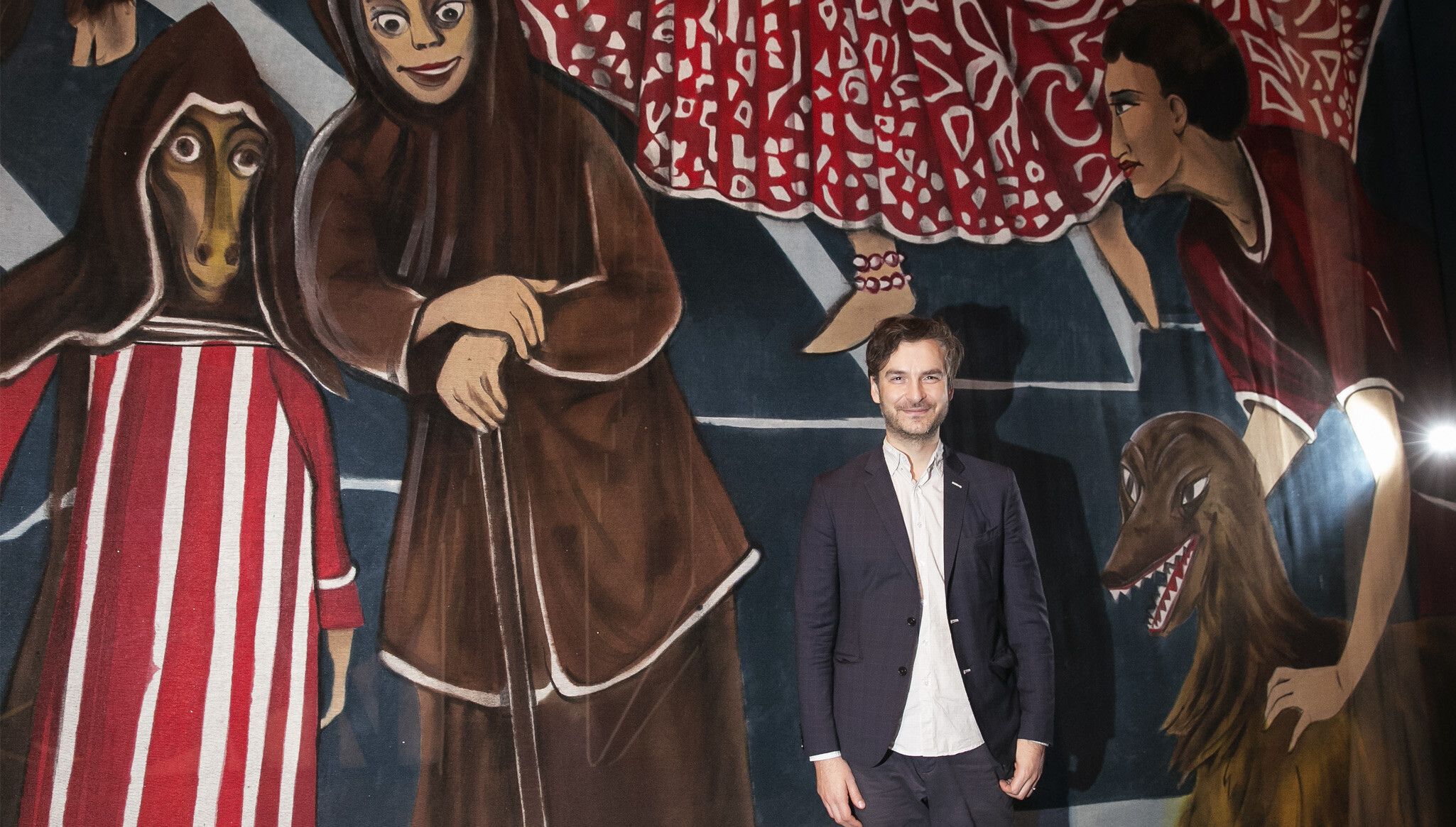 Marcel Dzama in front of his work in 2016. Photo by Erin Baiano