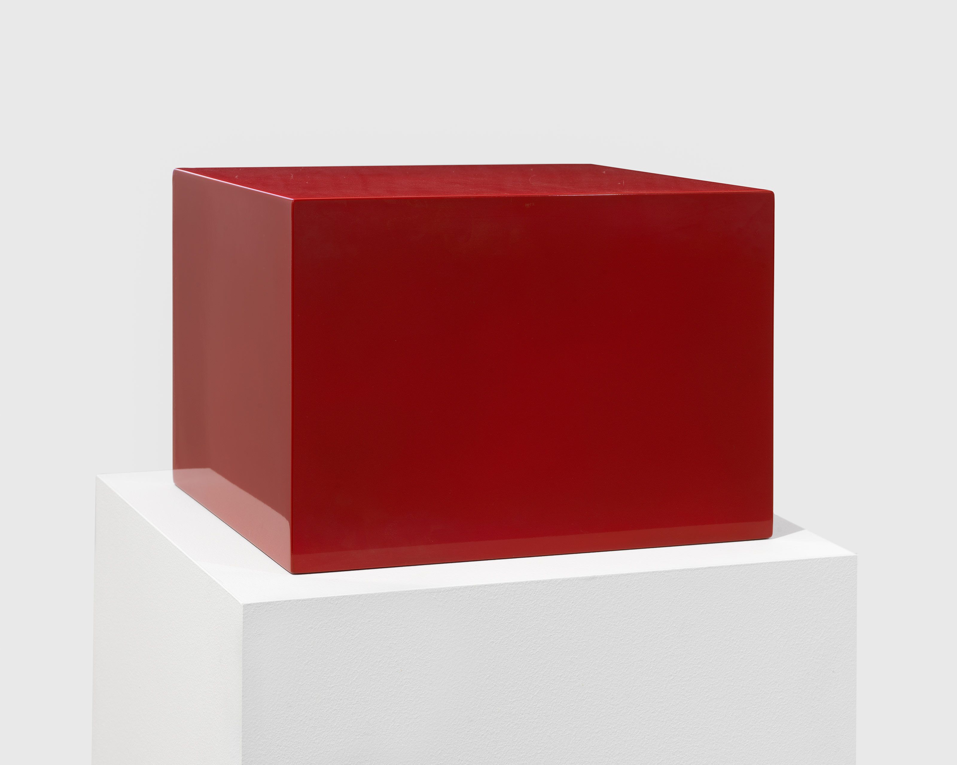 A lacquer, fiberglass, and plywood sculpture by John McCracken, titled Untitled (Red Block), dated 1966.