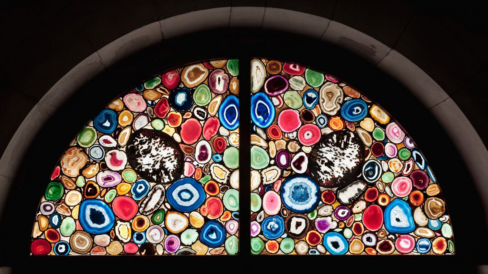 A photo of a glass window work by Sigmar Polke, titled Windows for the Zürich Grossmünster, dated 2009.