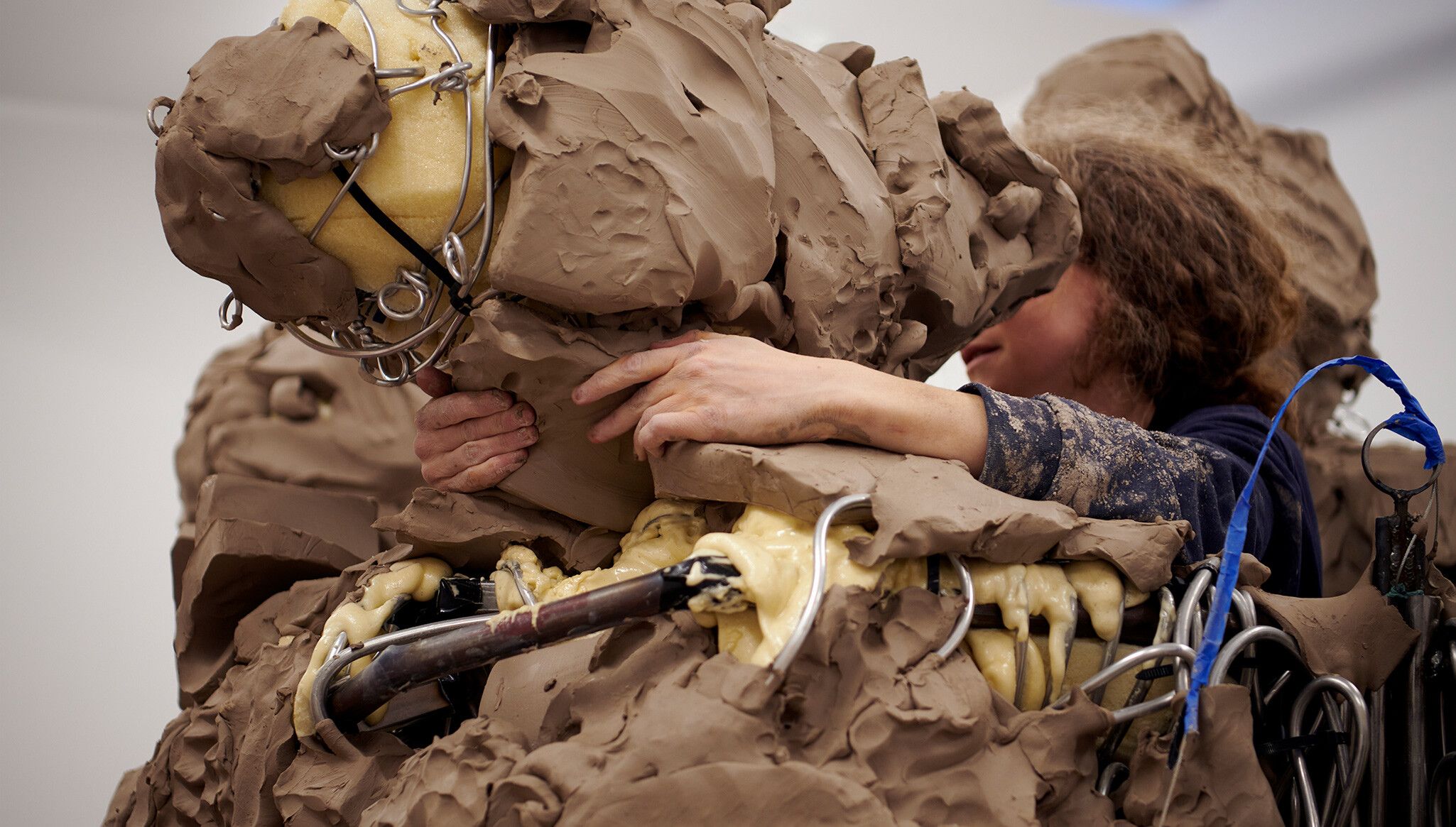 A photo of Schutz forming the clay structure for Sea Group (2022). Photo by Jason Scmidt.