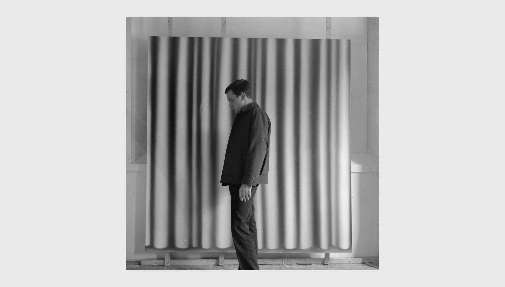 Gerhard Richter in front of the painting Vorhang IV (Cat. Rais. No. 57), in Düsseldorf, dated 1965. Photo by Gerhard Richter