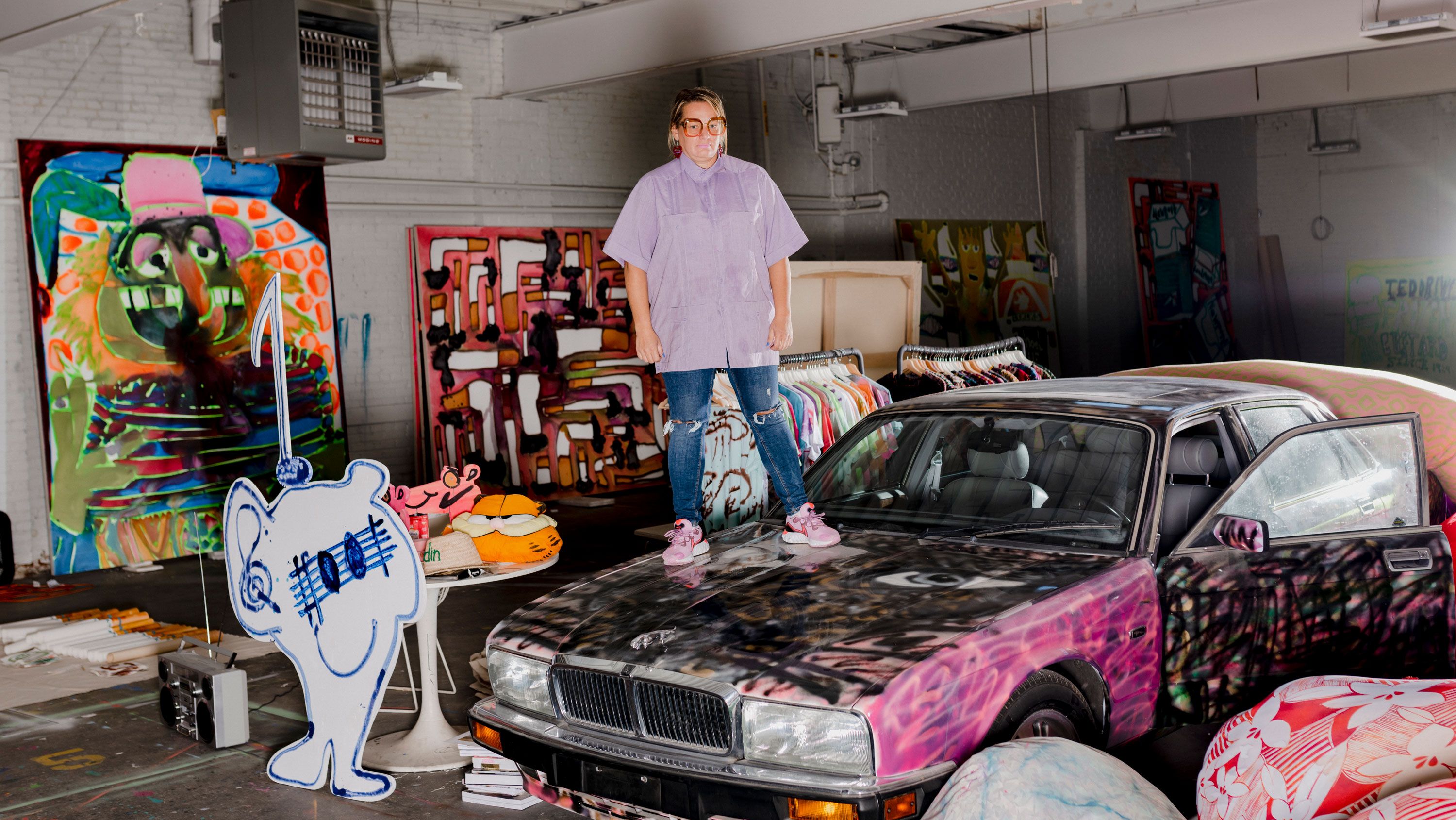 Bernhardt in her studio standing on a car. Photo by Lyndon French 