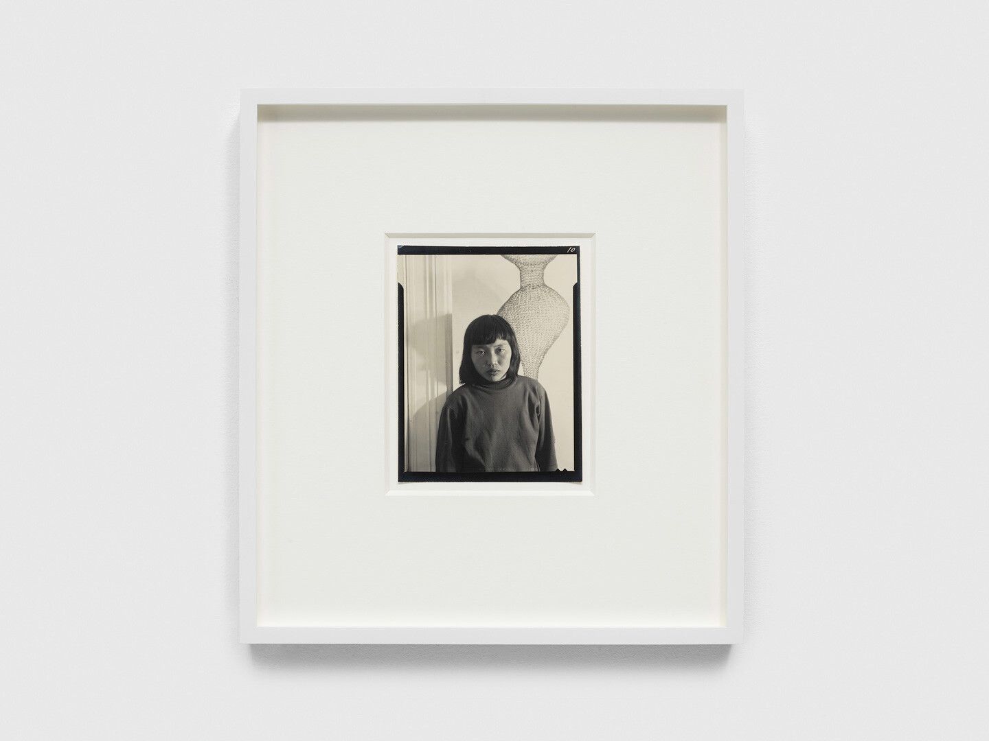 A gelatin silver print by Imogen Cunningham, titled Ruth Asawa and Her Wire Sculpture, dated 1951.
