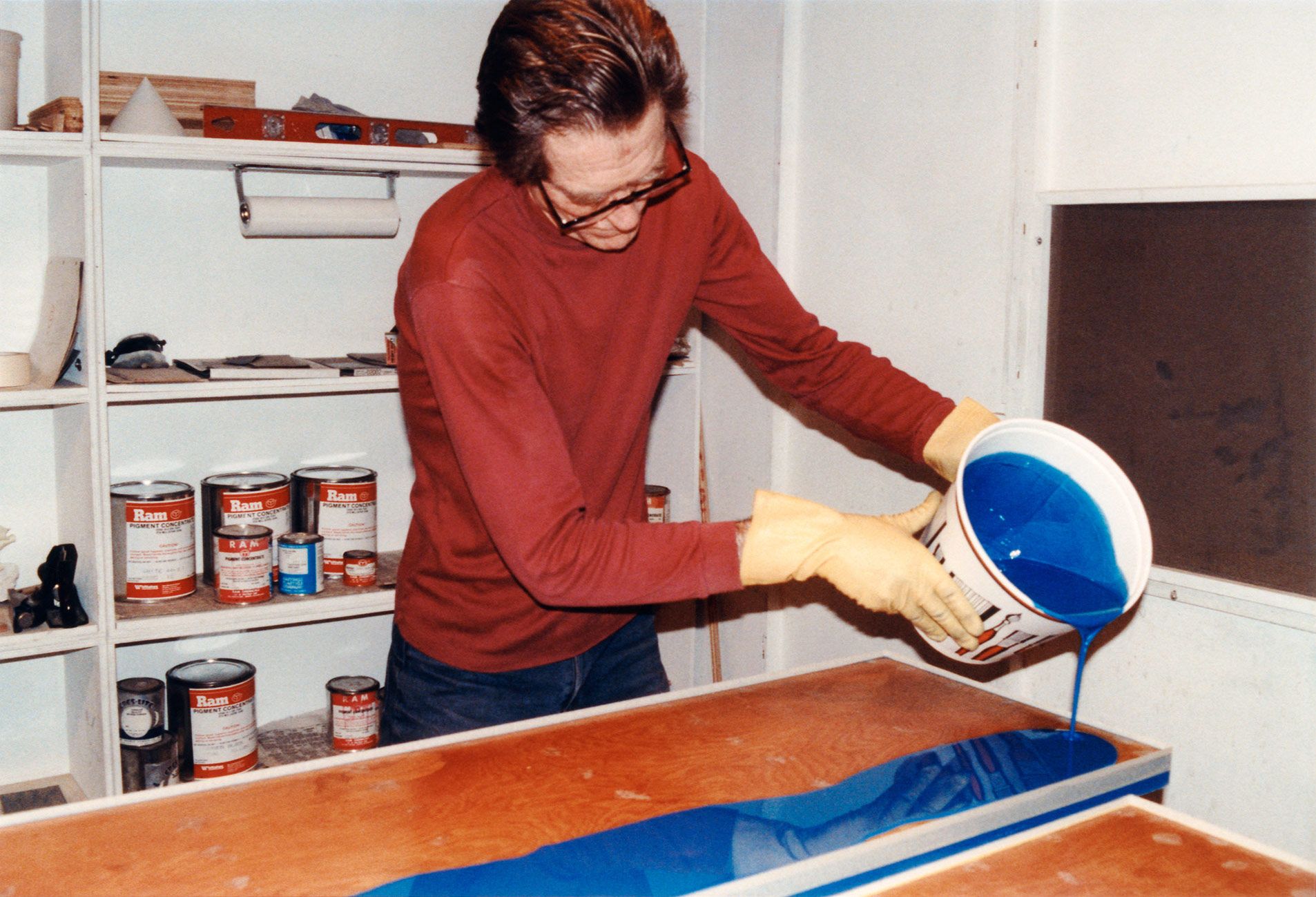 A photo of John McCracken working on a sculpture in his studio.