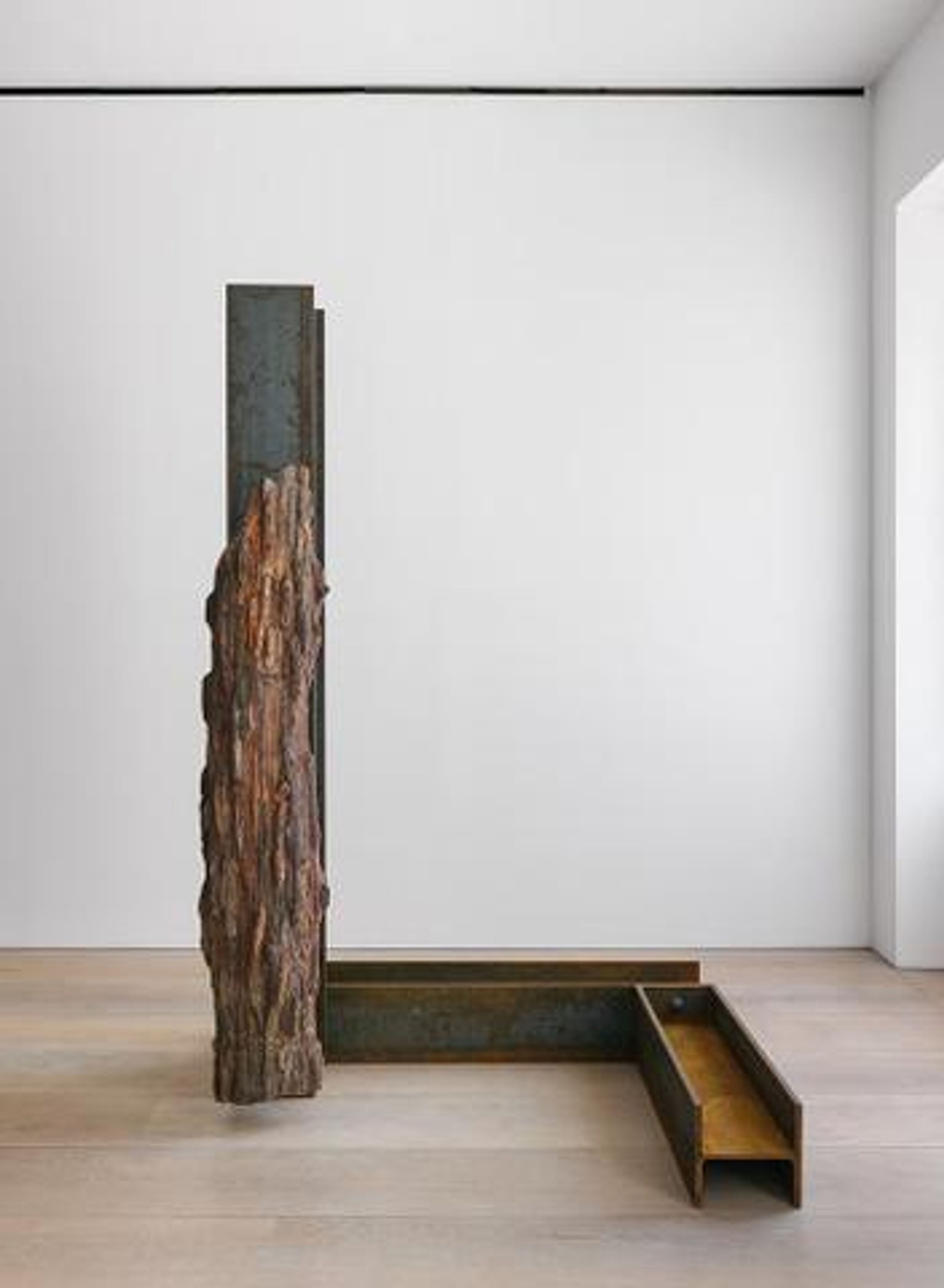 A petrified wood and steel sculpture by Carol Bove, titled Lingam, dated 2015.