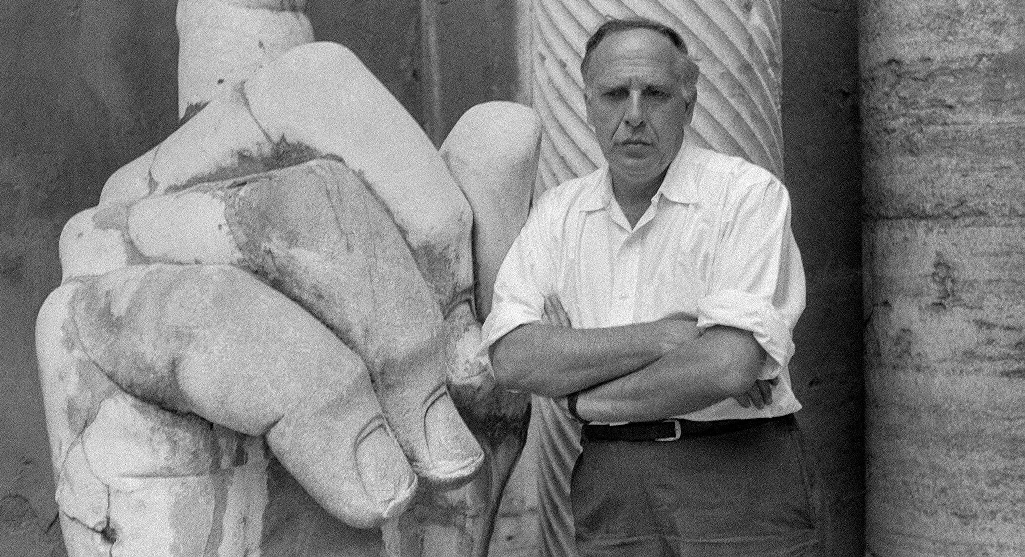 A photo of Philip Guston with the hand of the Colossus of Constantine in the courtyard of the Palazzo dei Conservatori, Rome, 1960.