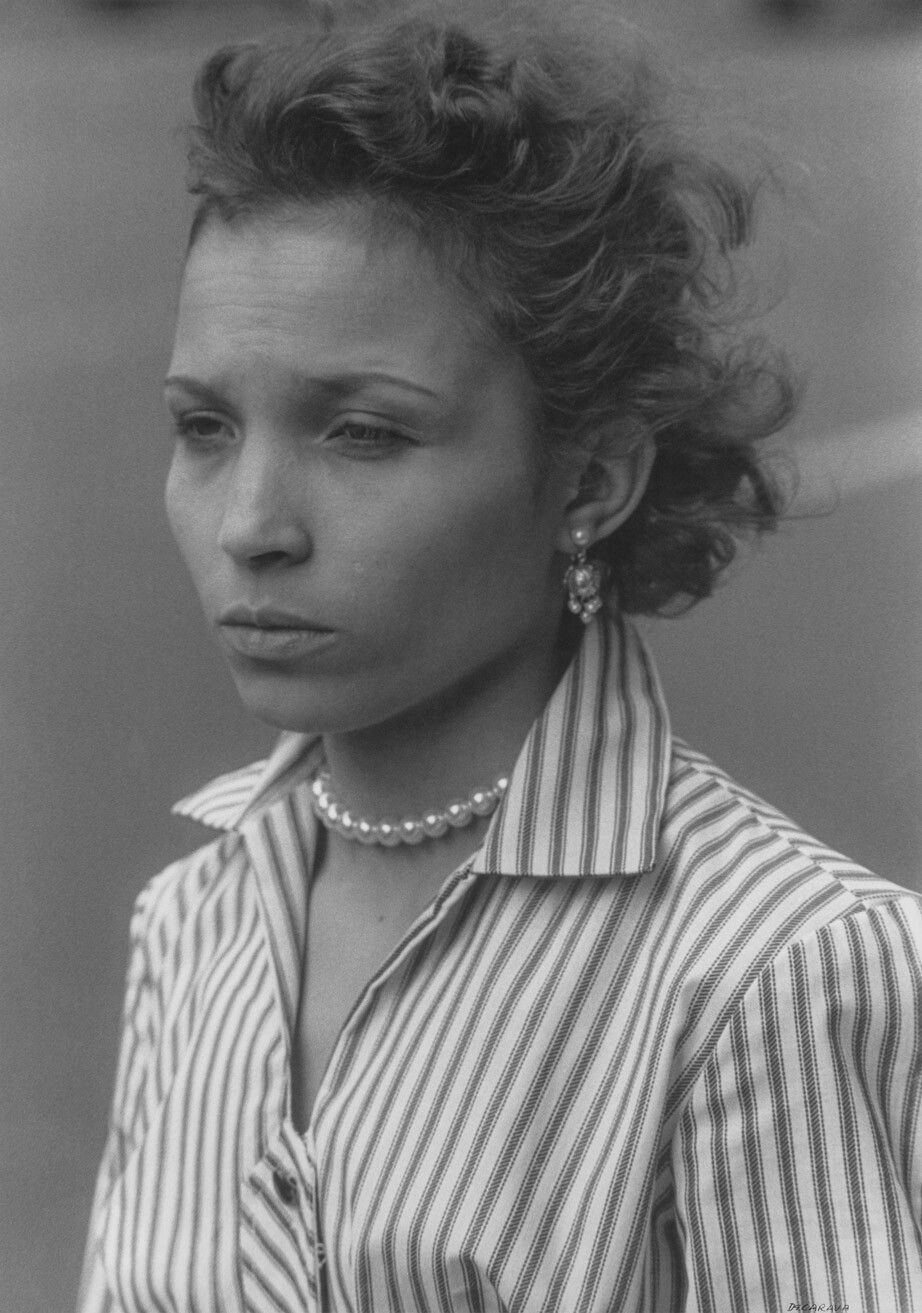A silver gelatin print by Roy DeCarava, titled Woman in striped blouse, dated 1956.