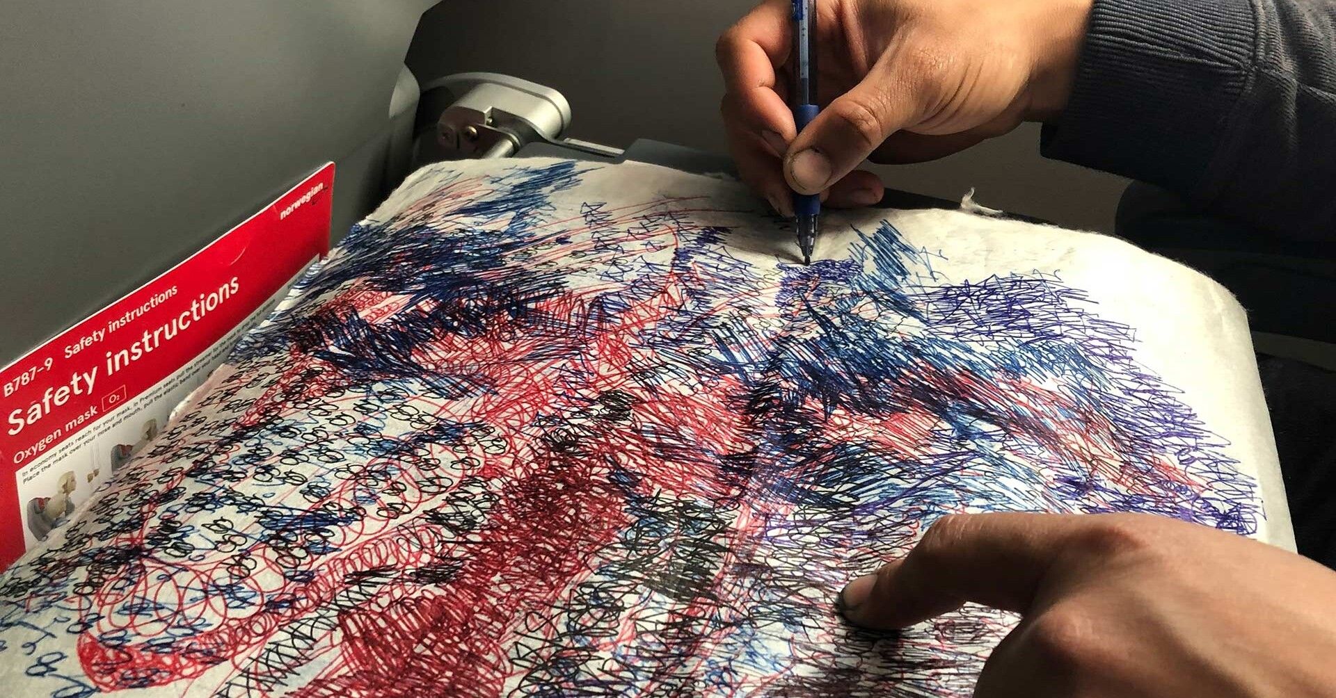 An image of an artist drawing on a textile