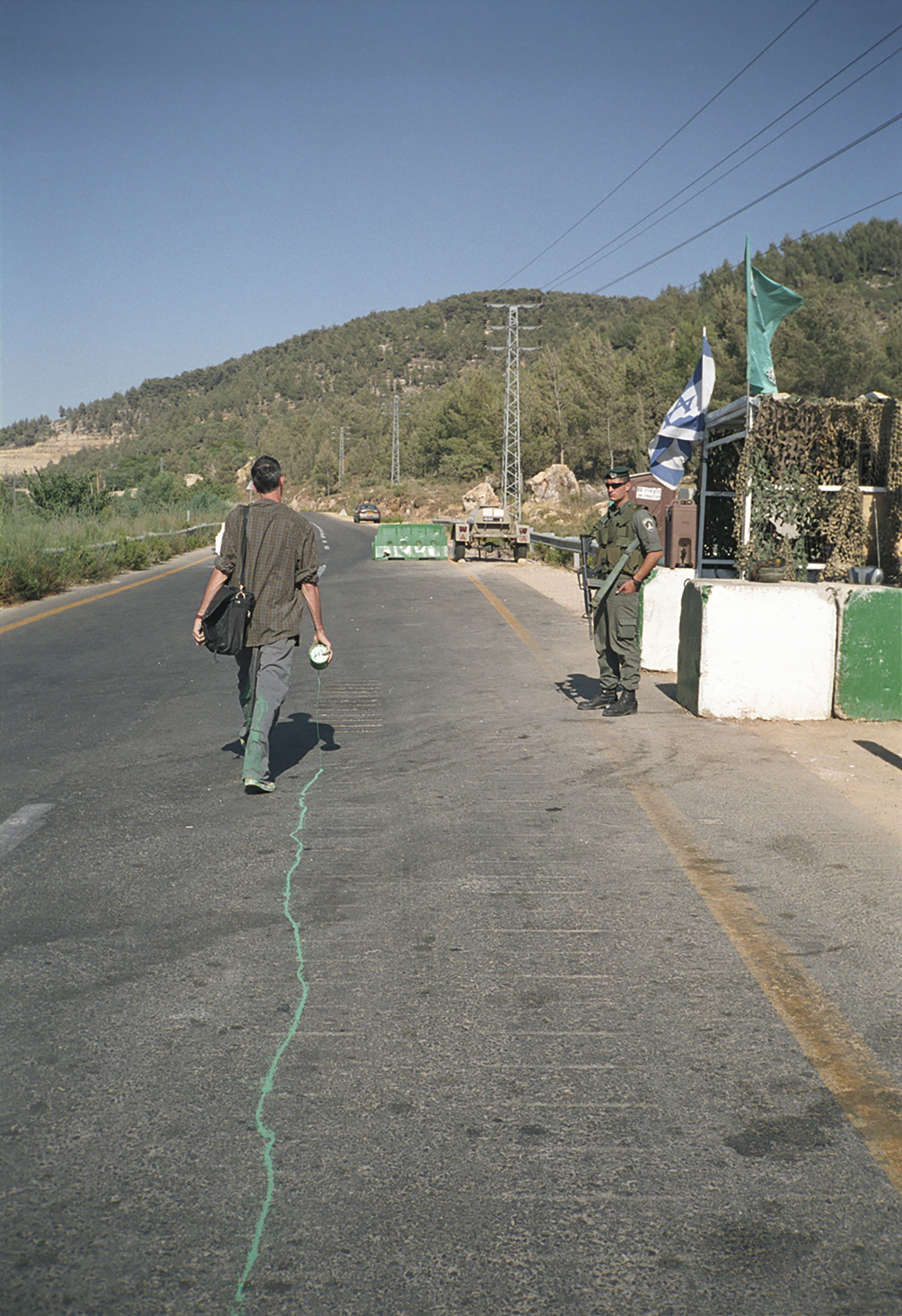 A video by Francis Alÿs, titled The Green Line (Sometimes doing something poetic can become political and sometimes doing something political can become poetic), dated 2004.