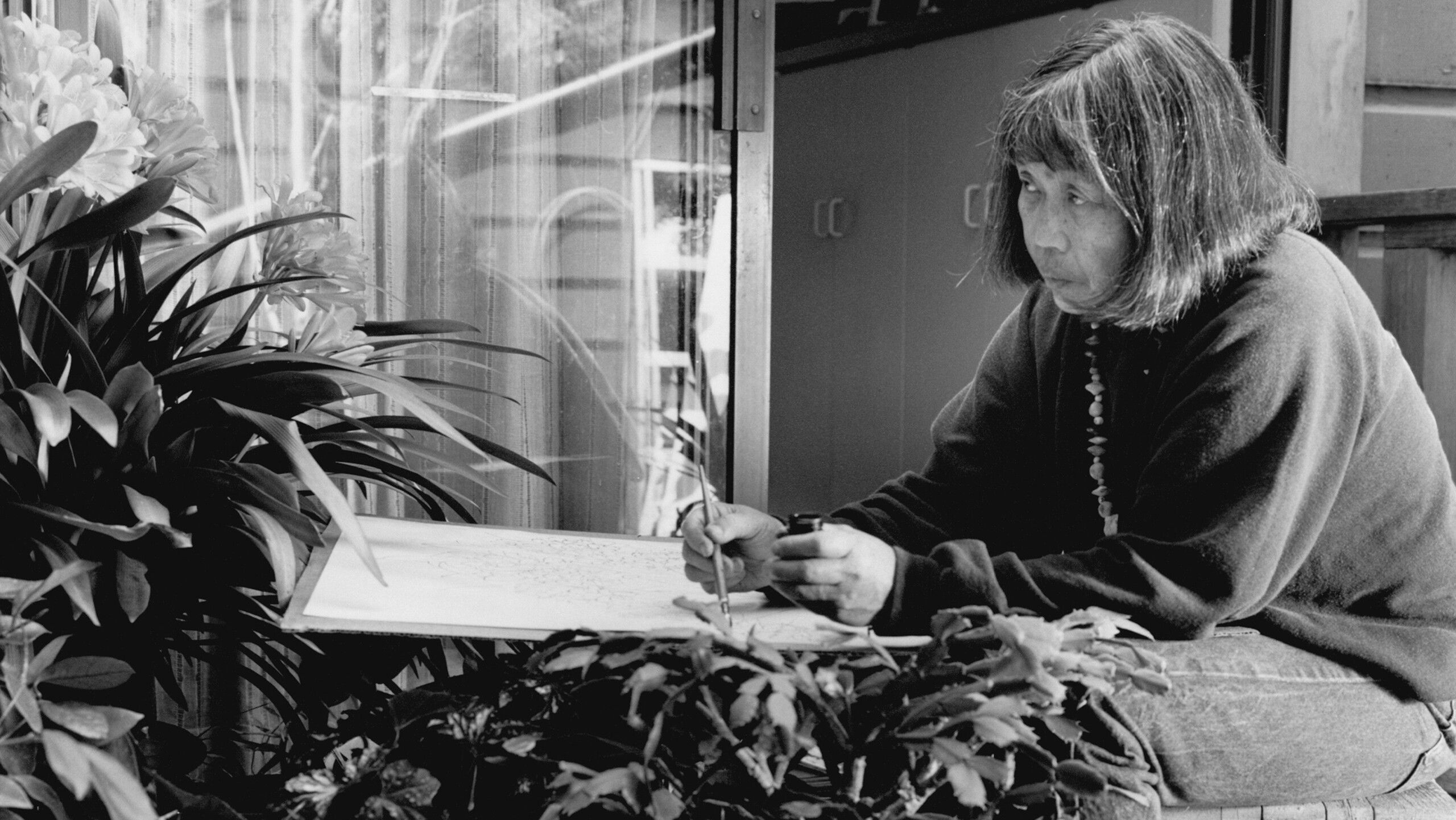 Ruth Asawa drawing flowers on the deck of her Noe Valley home. 