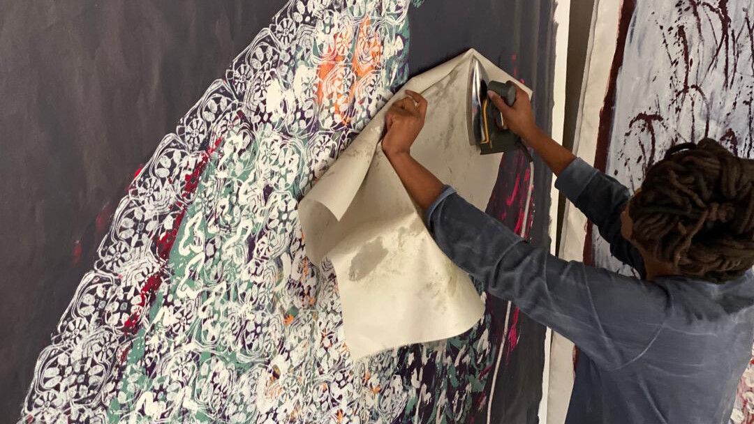 A photo of Portia Zvavahera working in her studio in Zimbabwe, in 2020.