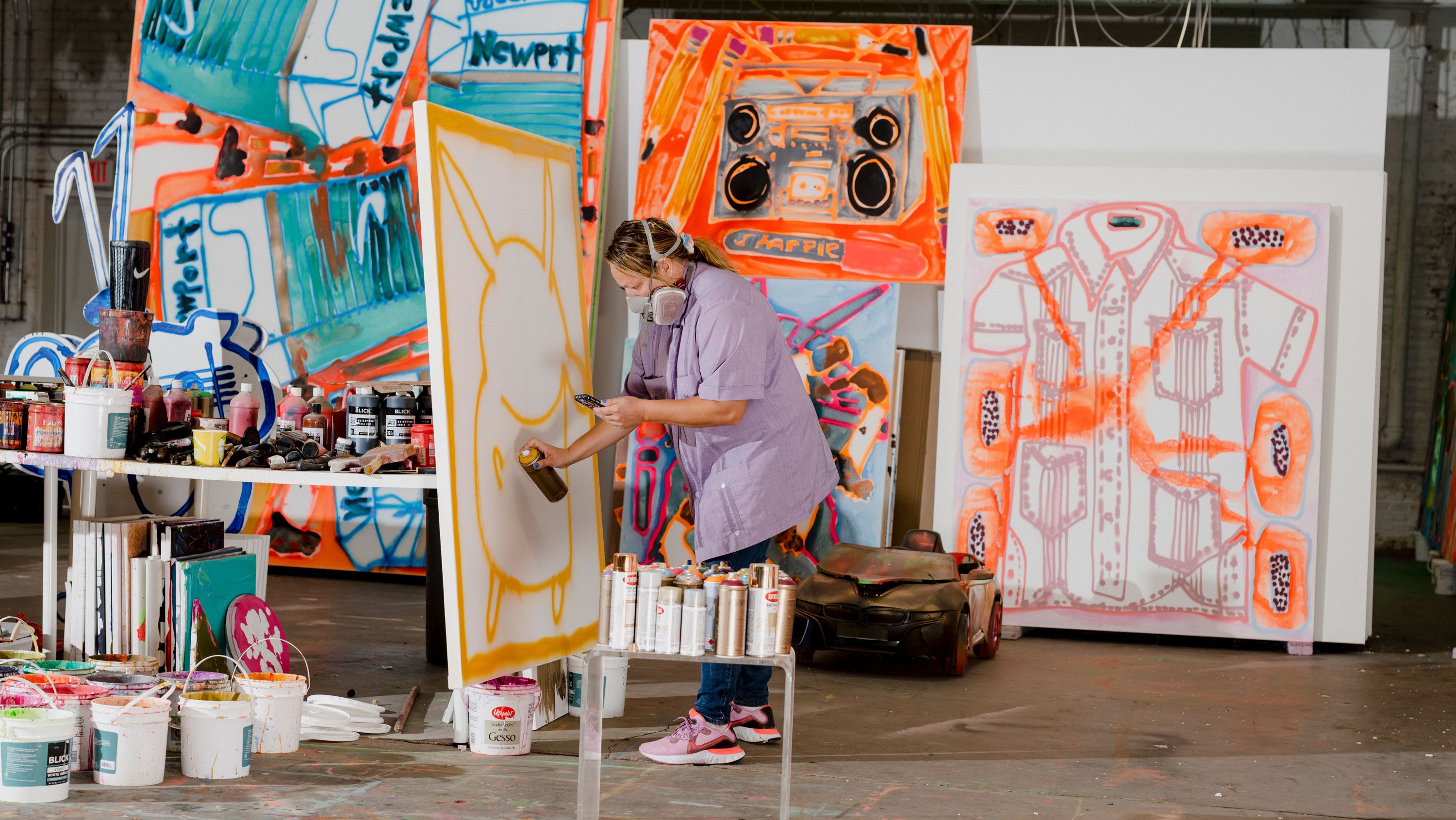 Bernhardt references a screenshot of a Pokémon character on her iPhone—inspired by her son, Khalifa—while painting. 