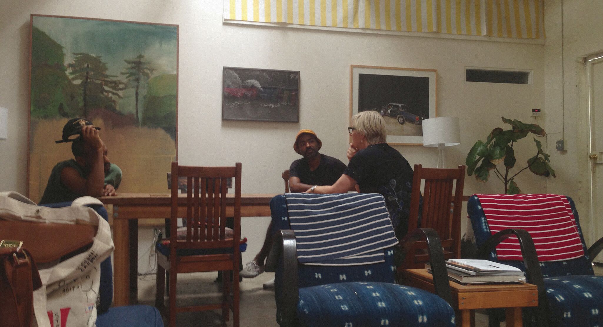 A photo of Noah Davis, Khalil Davis, and Helen Molesworth at The Underground Museum.