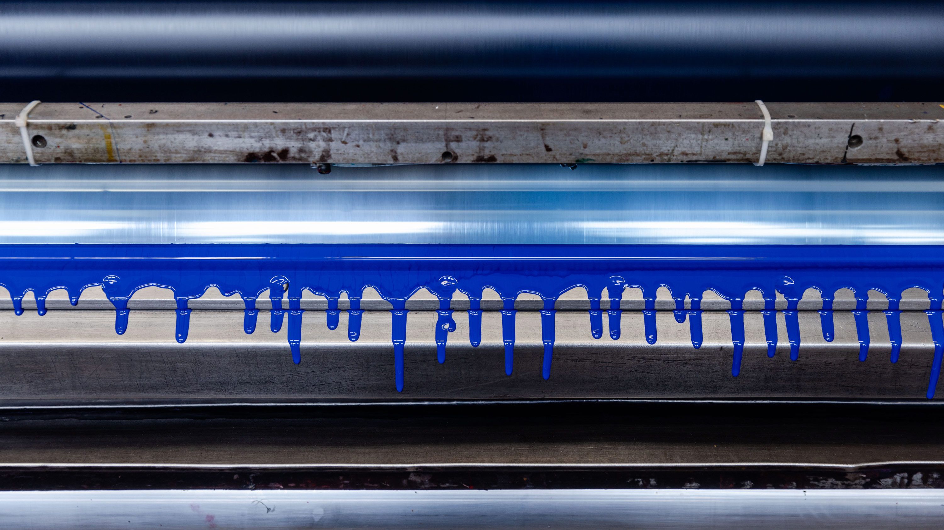 Ink drips as the printing press is cleaned. Photo by Max Burkhalter
