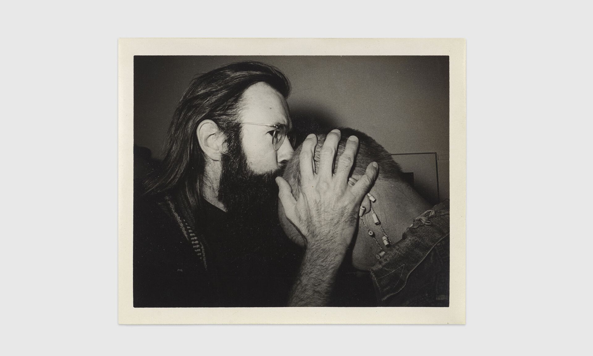 A photo by Jimmy DeSana of Geoffrey Hendricks kissing Ray Johnson’s head, dated c. 1972.