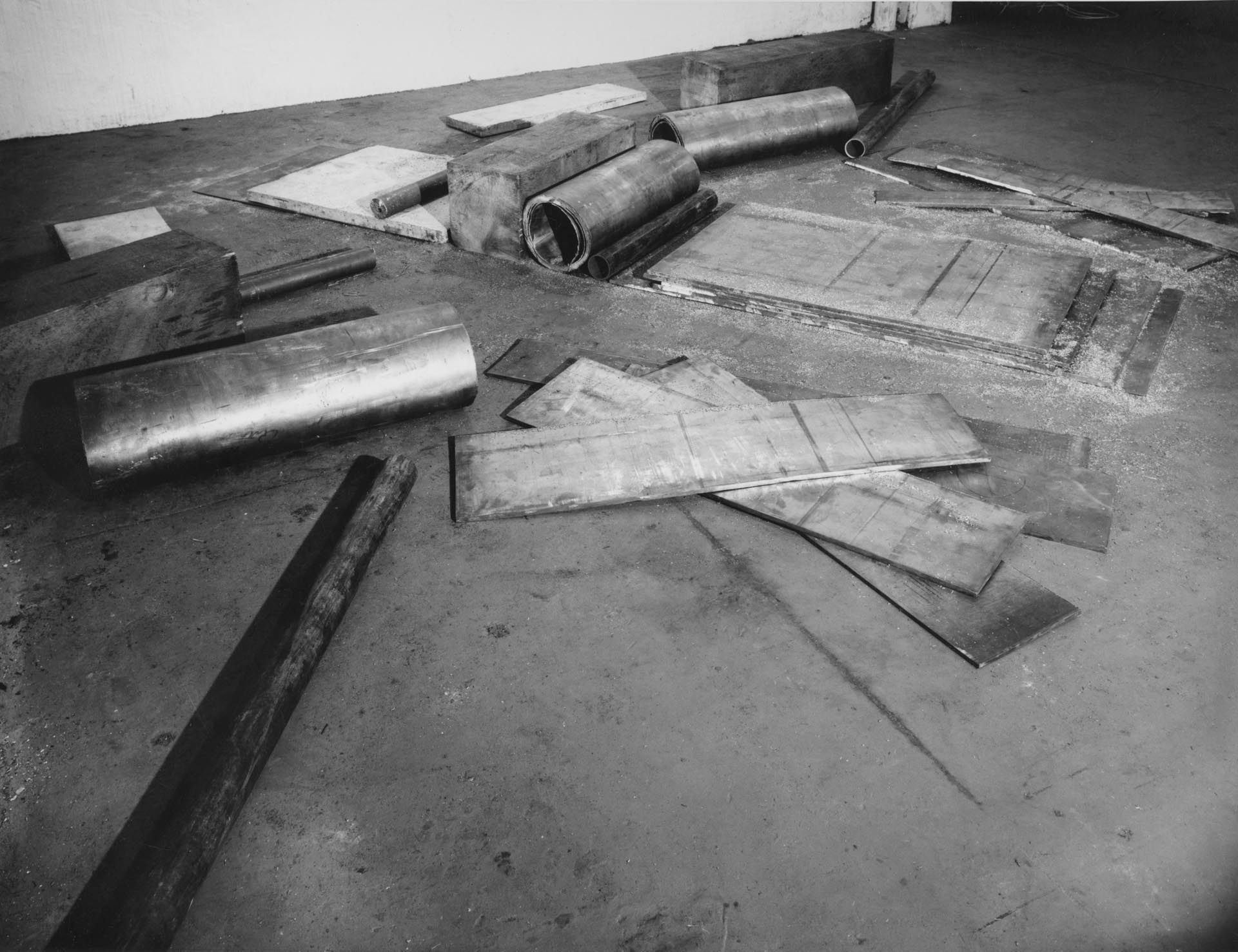 A lead, wood, stone and steel sculpture titled Cutting Device: Base Plate Measure, dated 1969.
