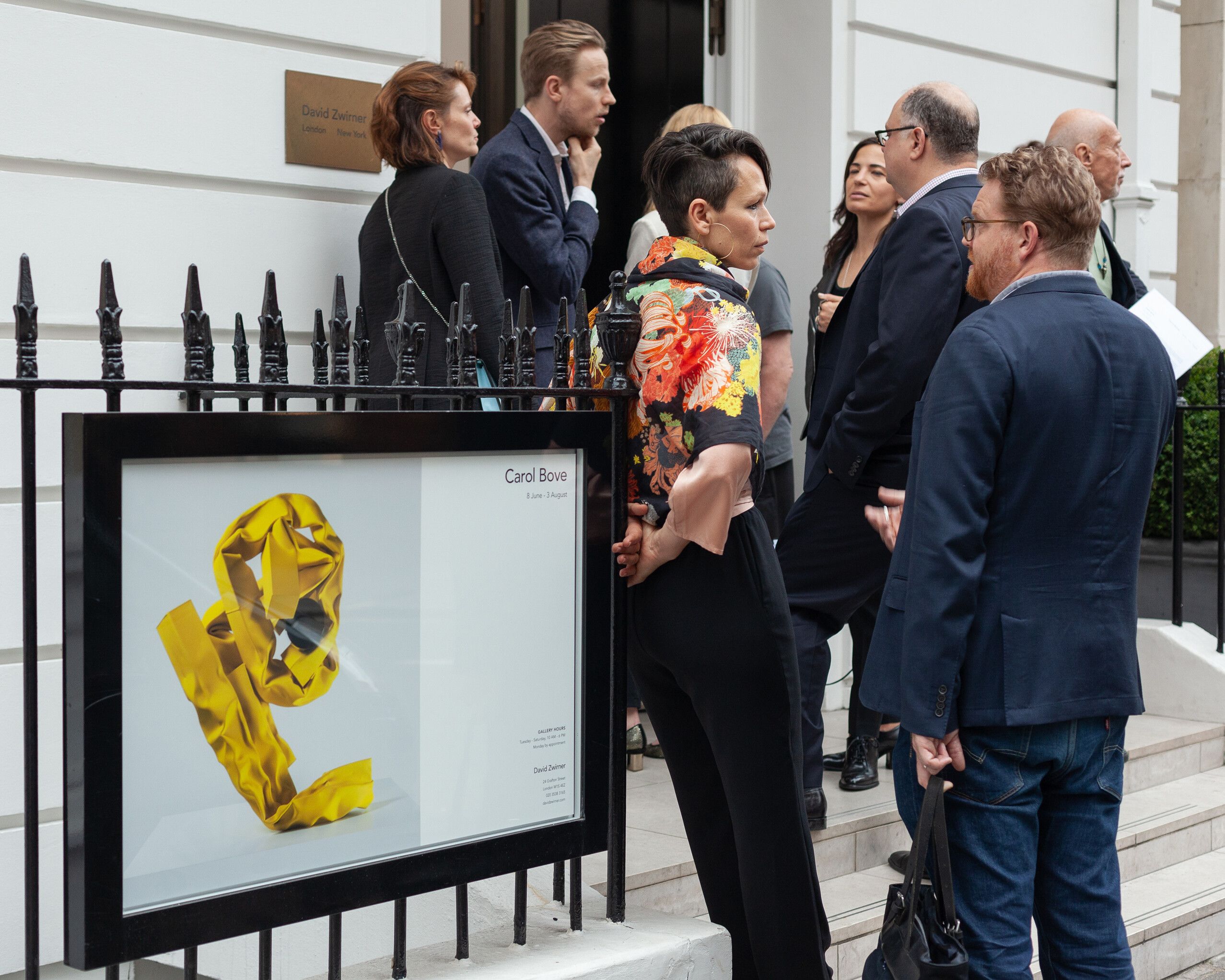 Carol Bove in conversation with a gallery visitor at the opening of her solo exhibition at David Zwirner London, dated 2018
