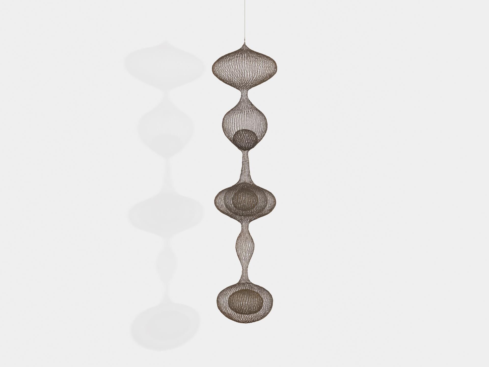 A sculpture by Ruth Asawa, titled Untitled (S.563, Hanging Six Lobed Form with Two Interior Spheres), dated 1956.