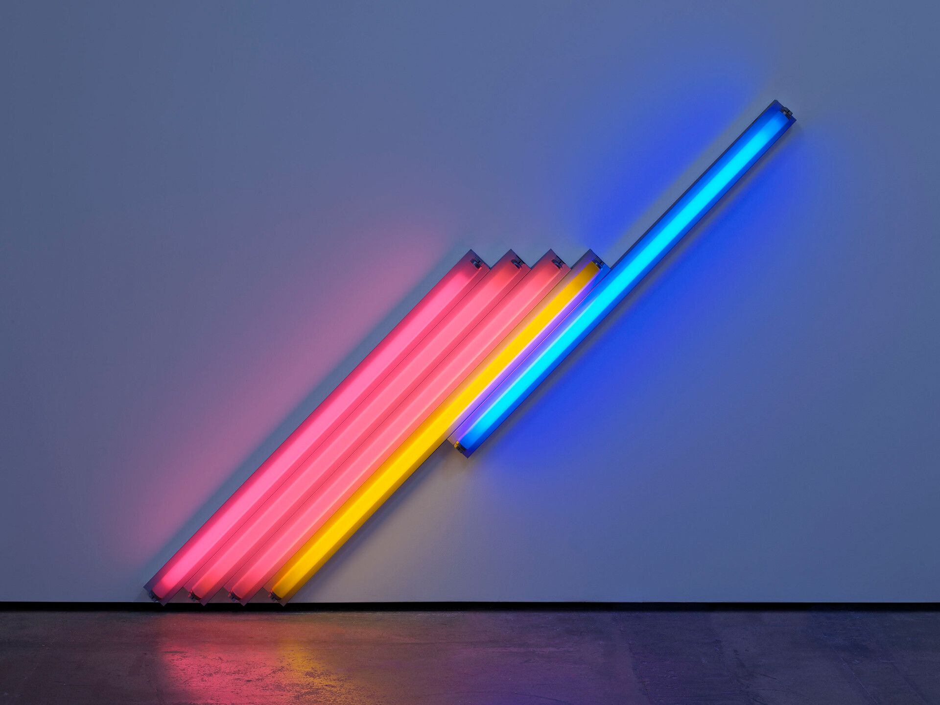 A pink, yellow, and blue fluorescent light sculpture by Dan Flavin, titled untitled (for Frederika and Ian) 3, dated 1987.