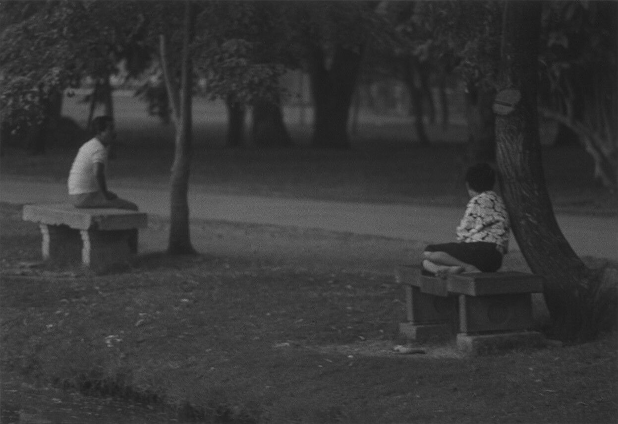A silver gelatin print by Roy DeCarava, titled Two people sitting, Bangkok, dated 1978.