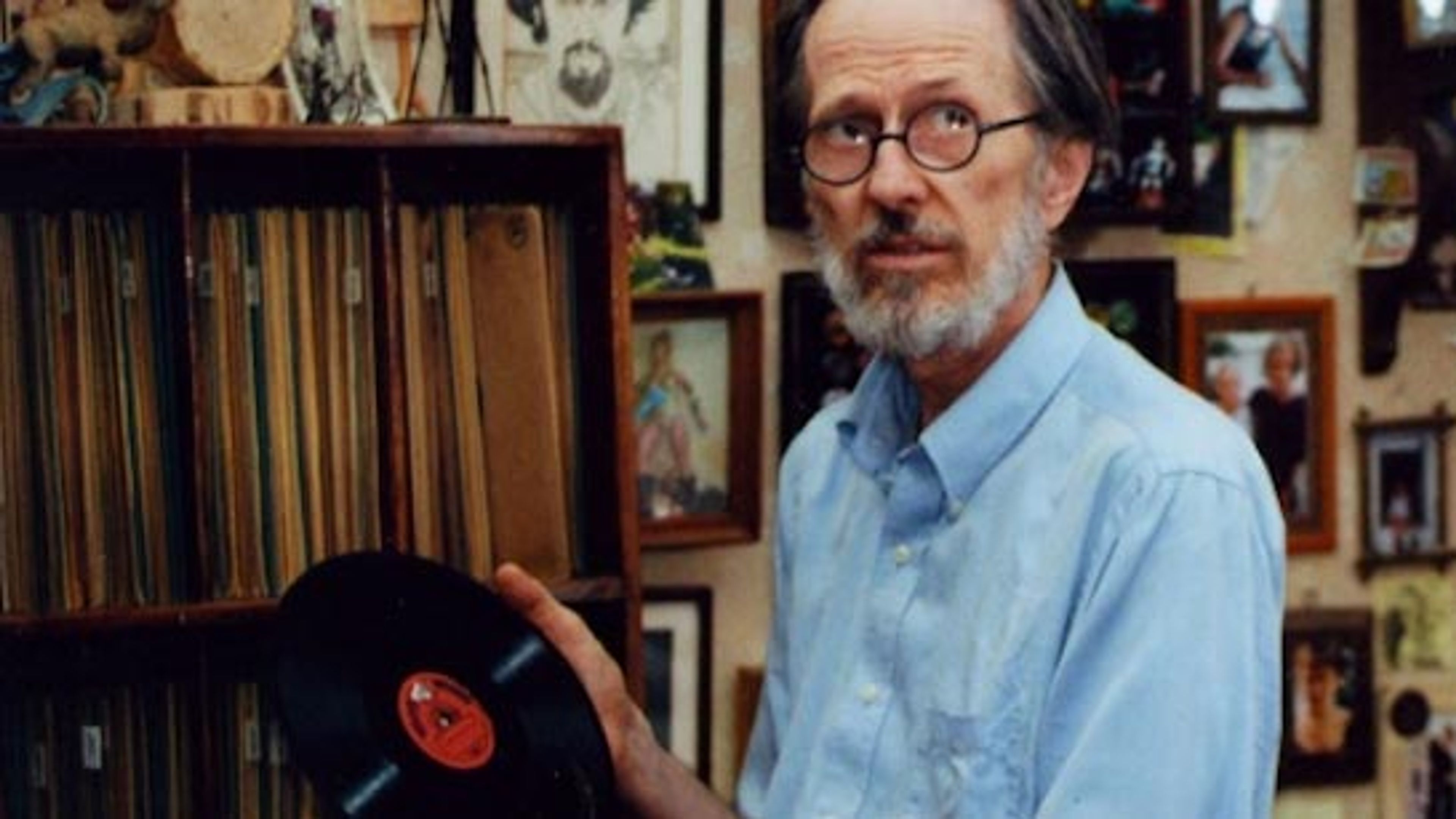 R. Crumb (Robert Crumb) holding an LP record.