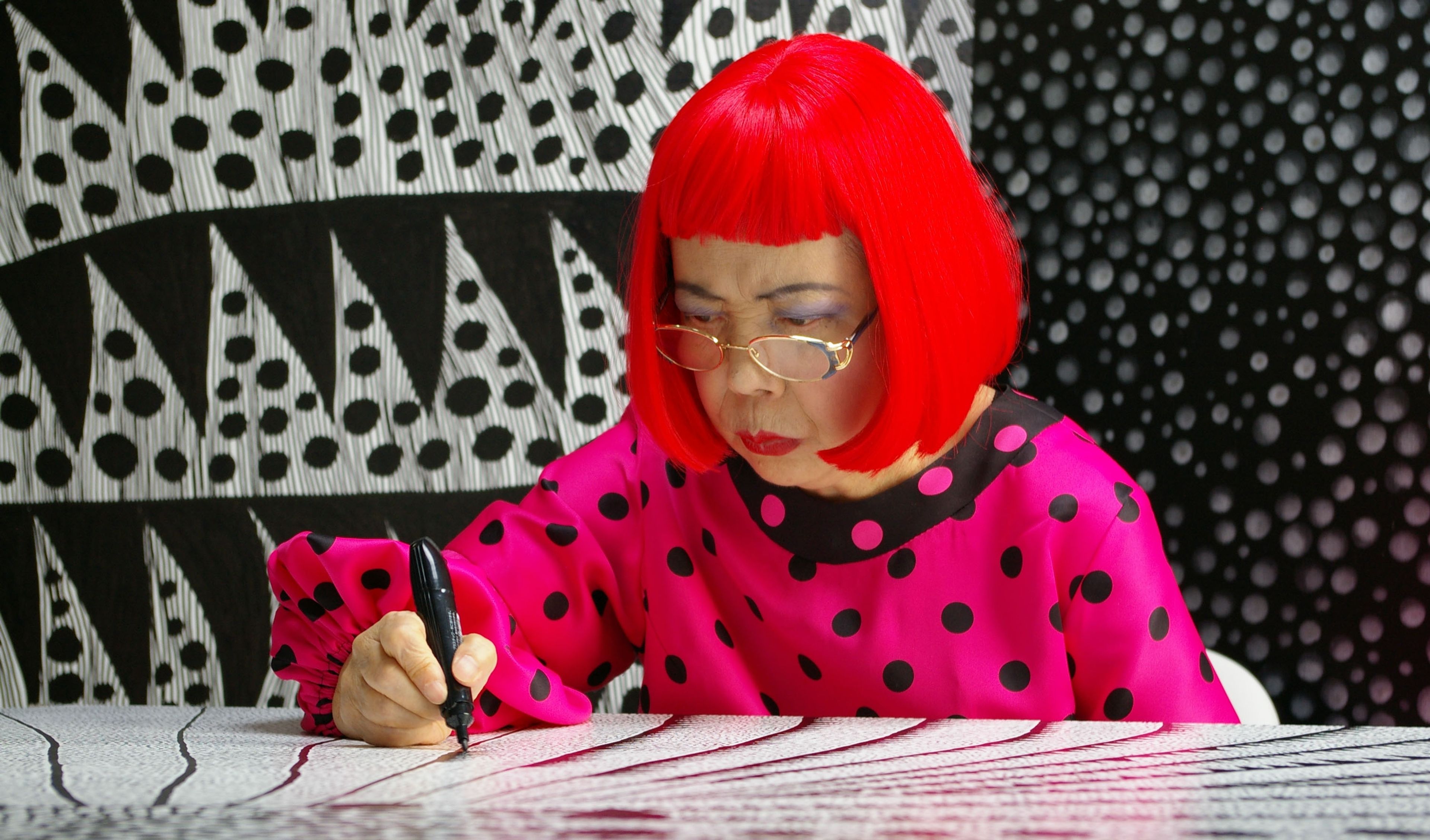 Yayoi Kusama drawing in the 2018 documentary film, titled Kusama - Infinity, directed by Heather Lenz.